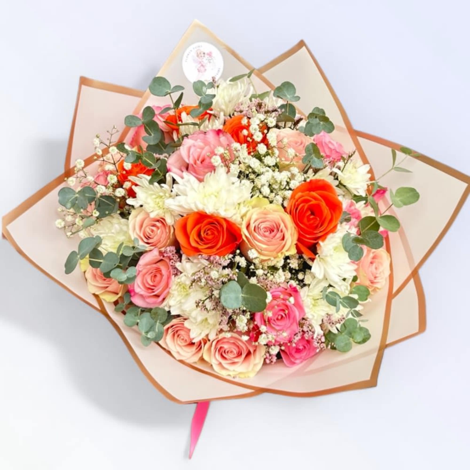 Bouquet of pink and orange roses with white flowers and eucalyptus