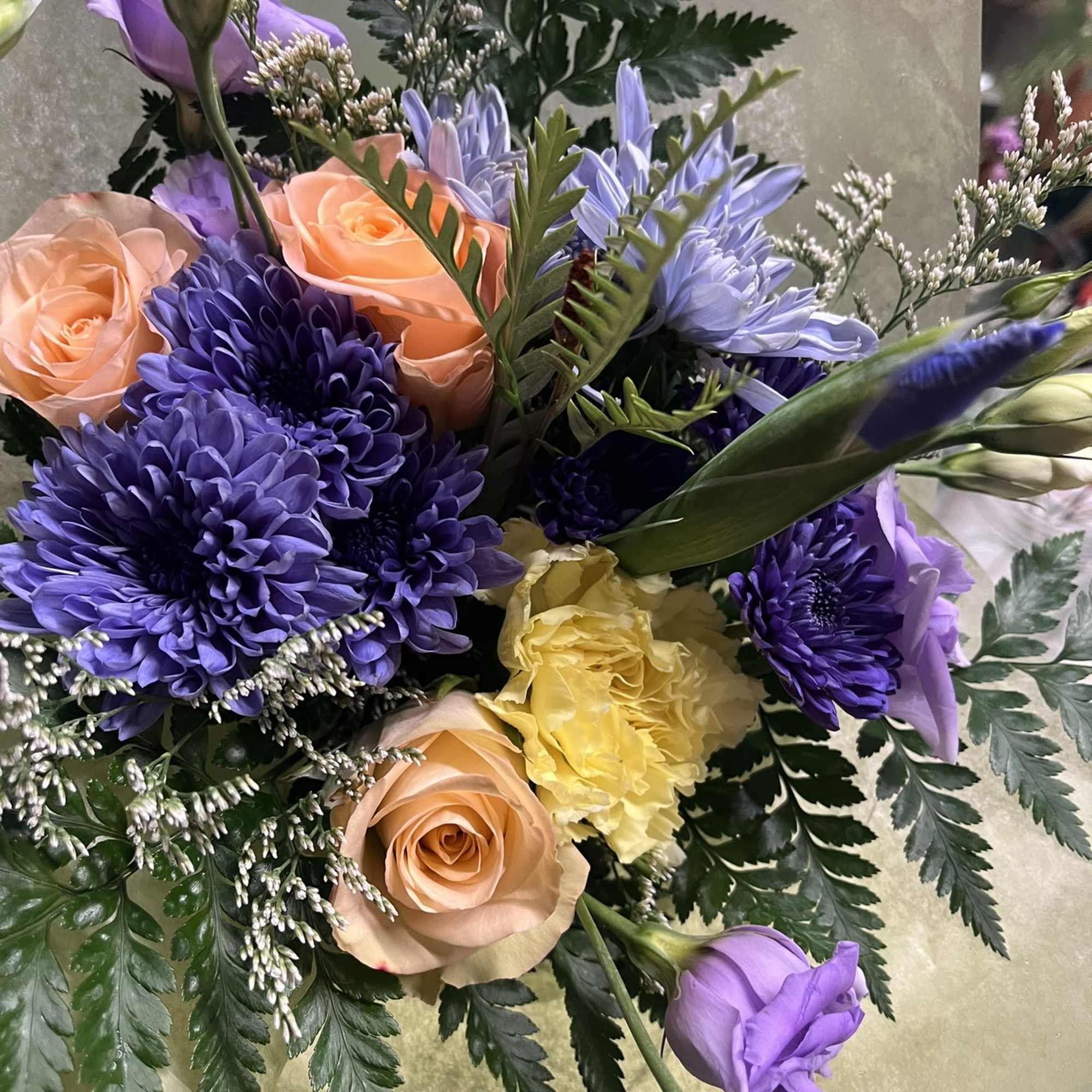 Bouquet of purple and peach flowers with yellow accents