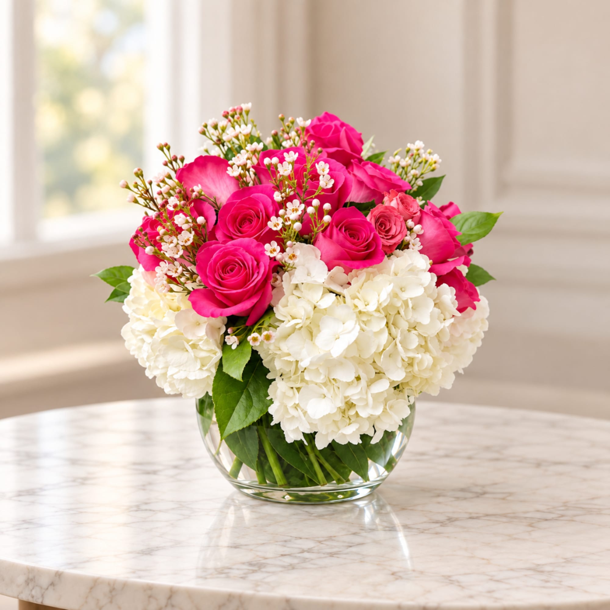 Pink roses and white hydrangeas in a clear glass vase, photo 2 of 4