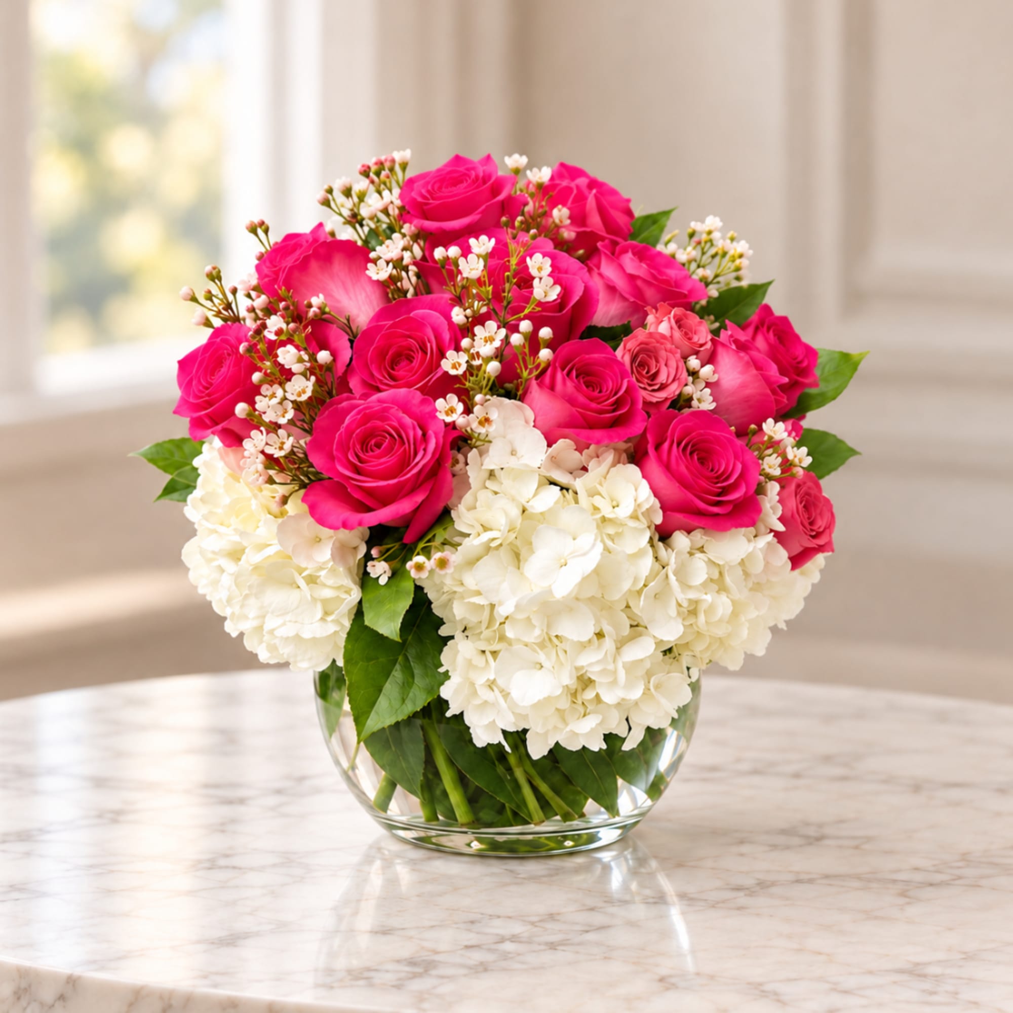 Pink roses and white hydrangeas in a clear glass vase, photo 2 of 2