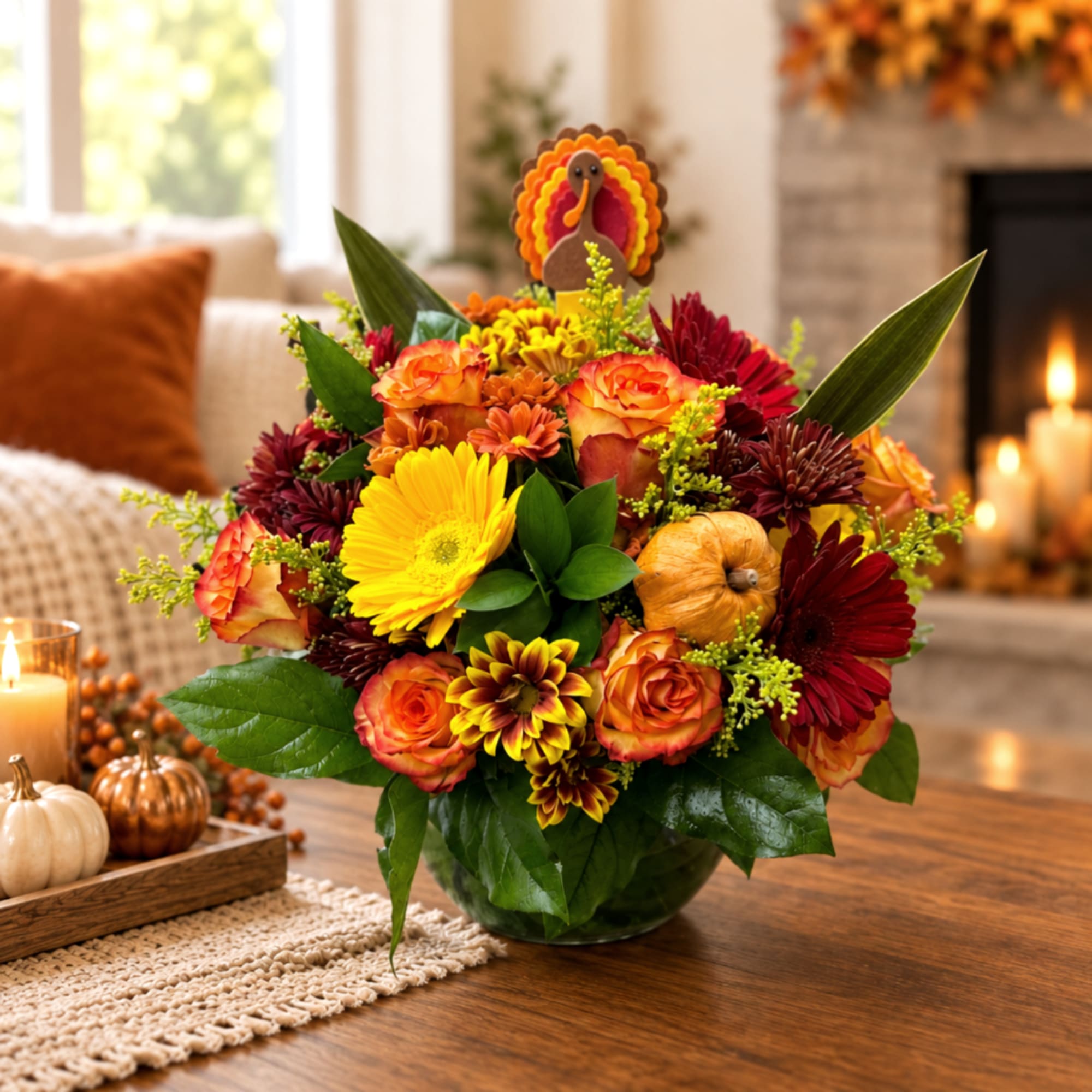 Autumn bouquet in a glass vase with orange, yellow, and burgundy flowers