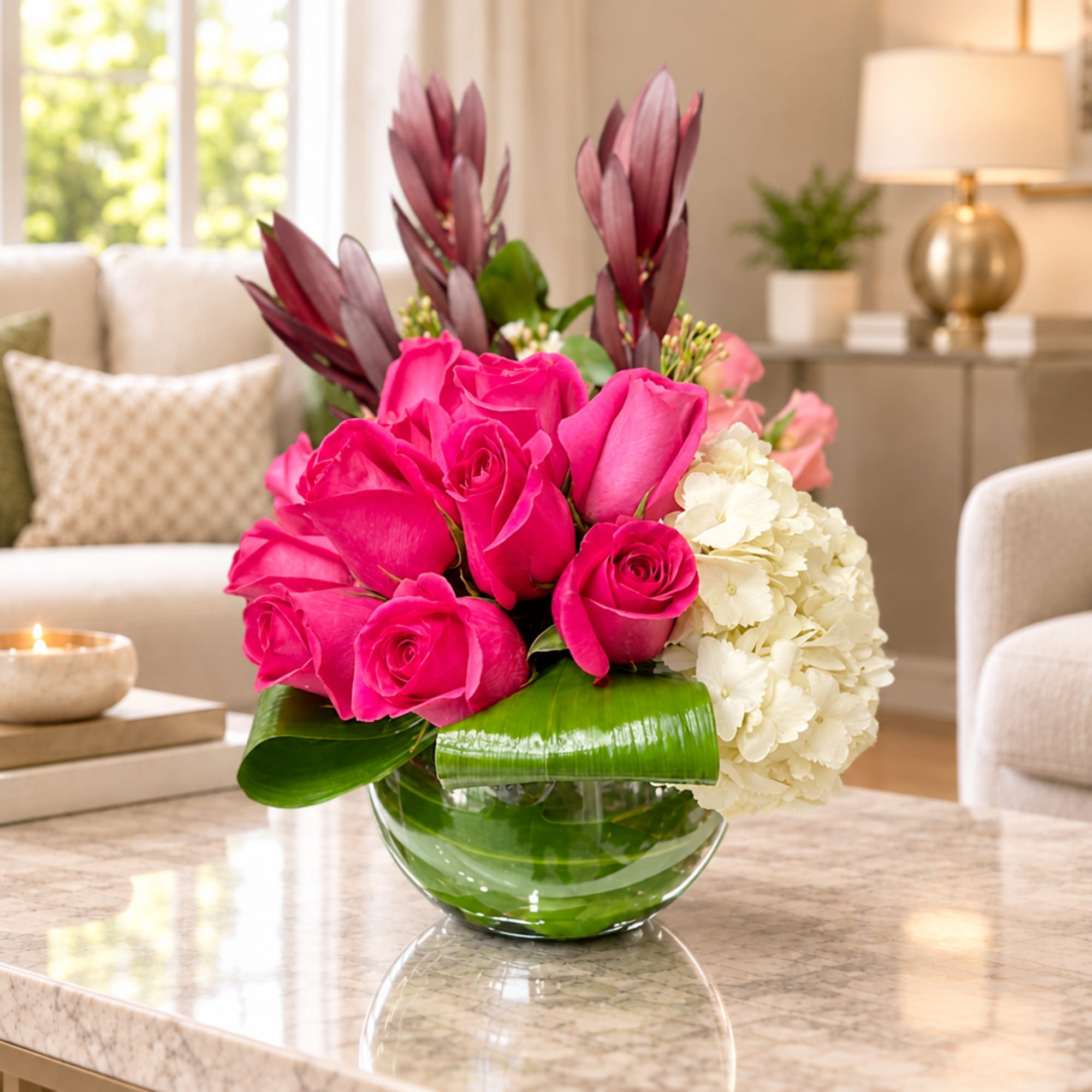 Pink roses and white hydrangeas in a glass bowl vase