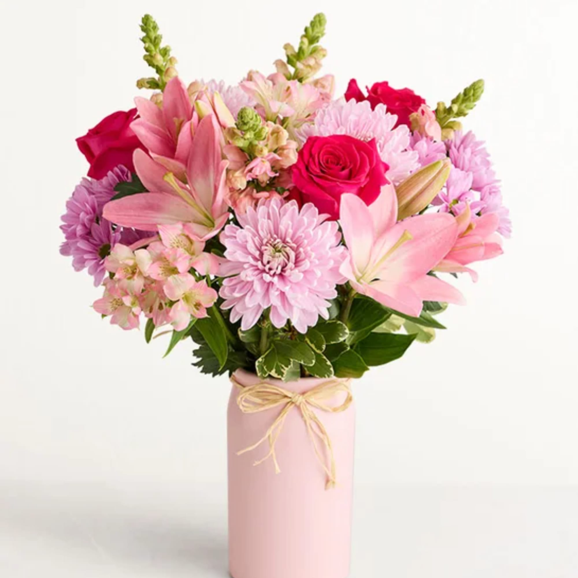 Pink and red mixed bouquet in a pink vase with a ribbon