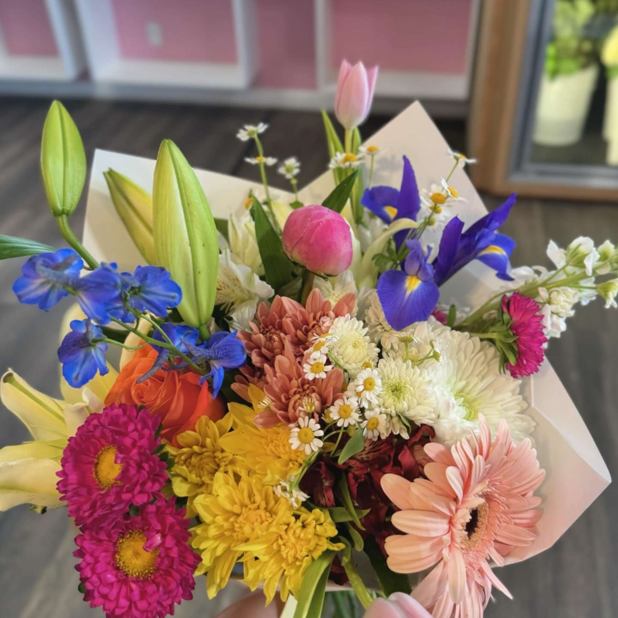 Colorful mixed bouquet with lilies, tulips, daisies, and gerbera daisies