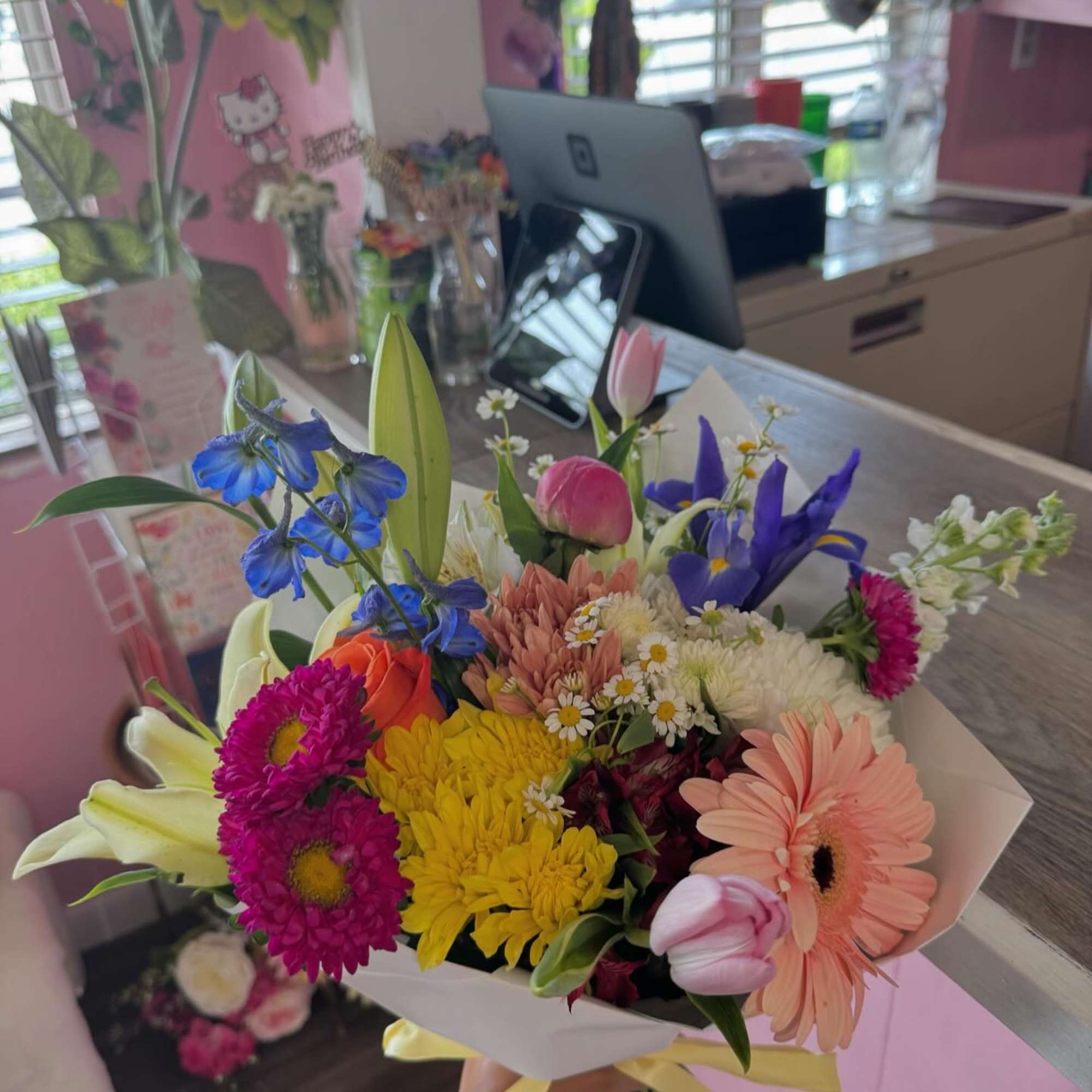 Colorful mixed bouquet with gerbera daisies, tulips, lilies, and chrysanthemums