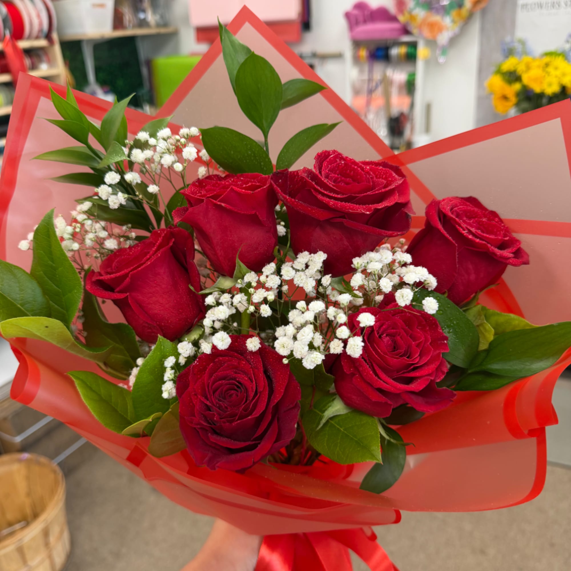 Bouquet of red roses with white baby's breath in red wrap, photo 3 of 3