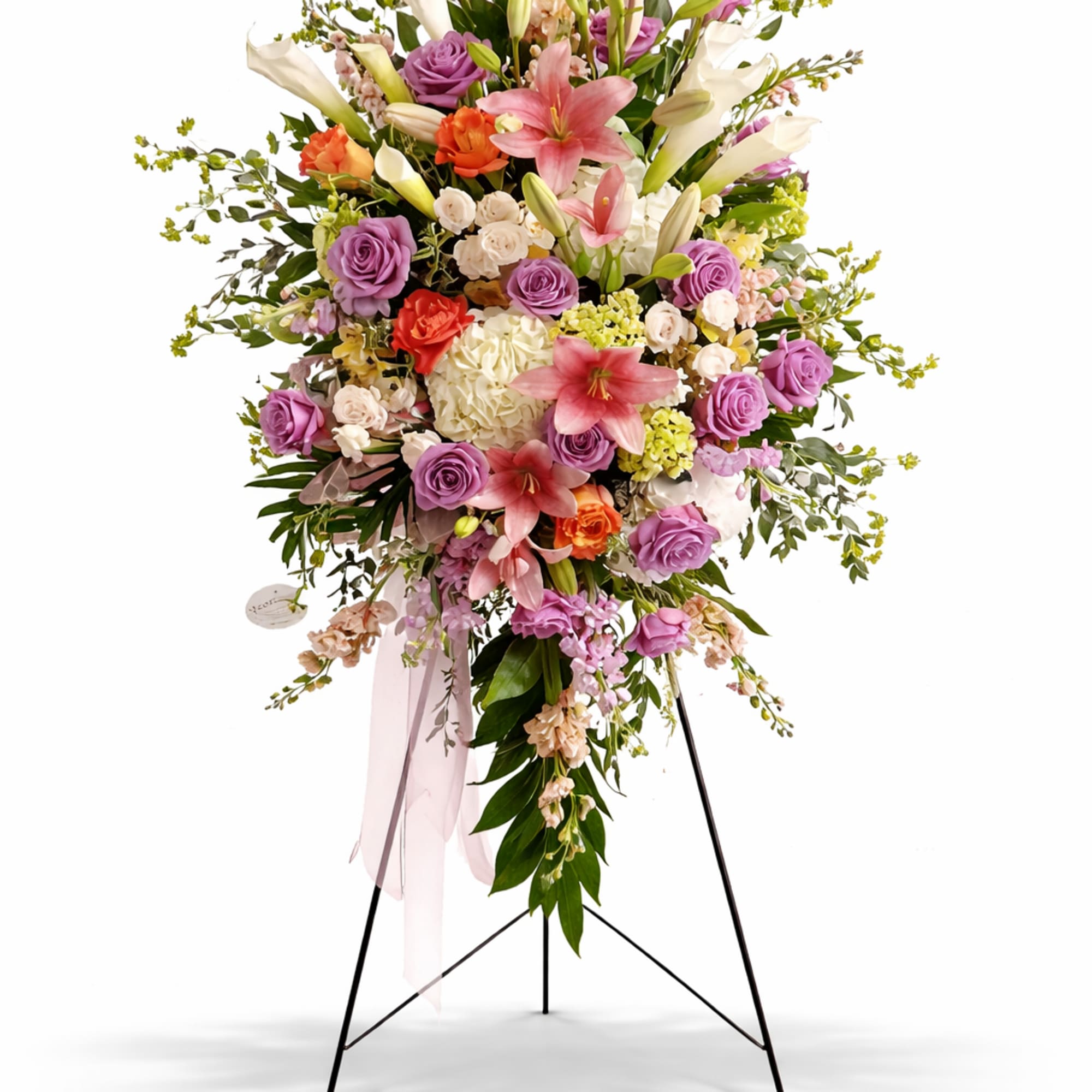 Standing floral spray with pink lilies, purple roses, and white blooms