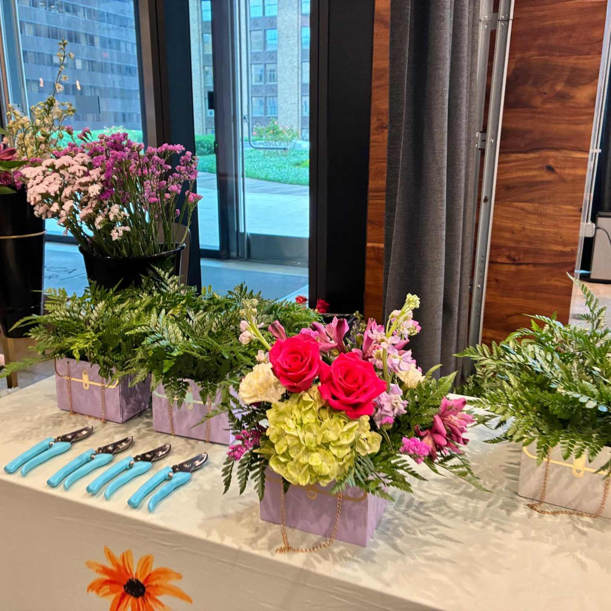 An engaging floral activity where guests create their own arrangements with guidance, photo 2 of 4