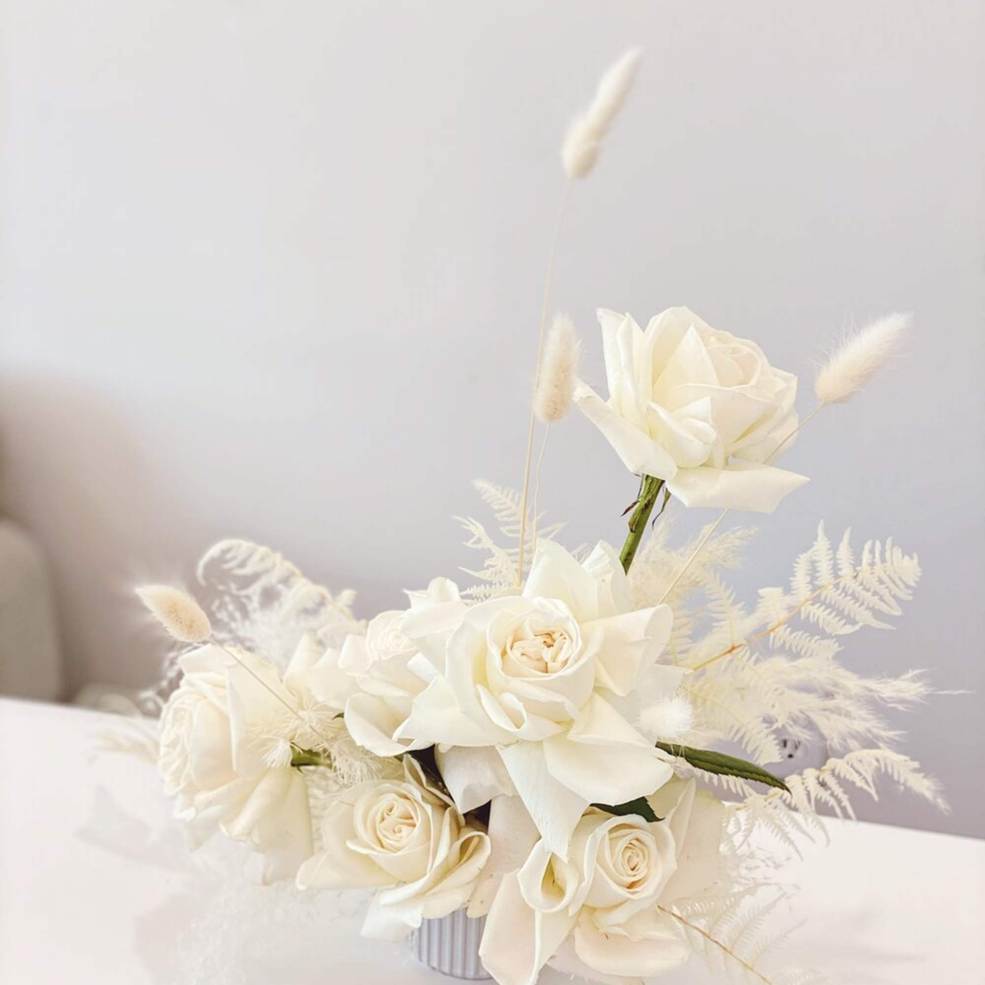 White roses and calla lilies in a small vase with airy dried accents, photo 3 of 5
