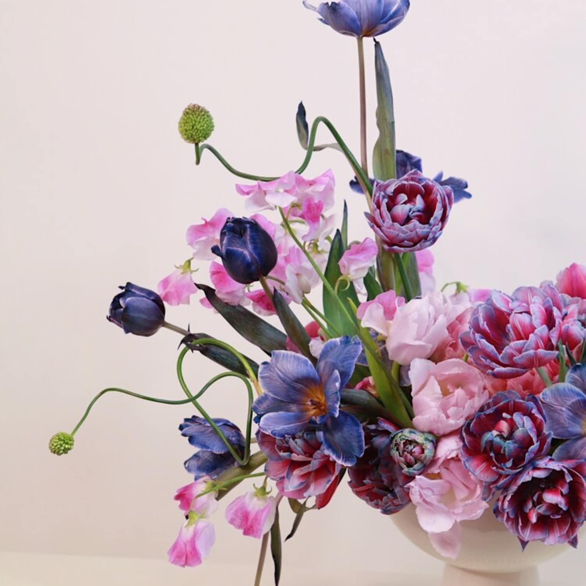 Blue and pink mixed bouquet in a white vase