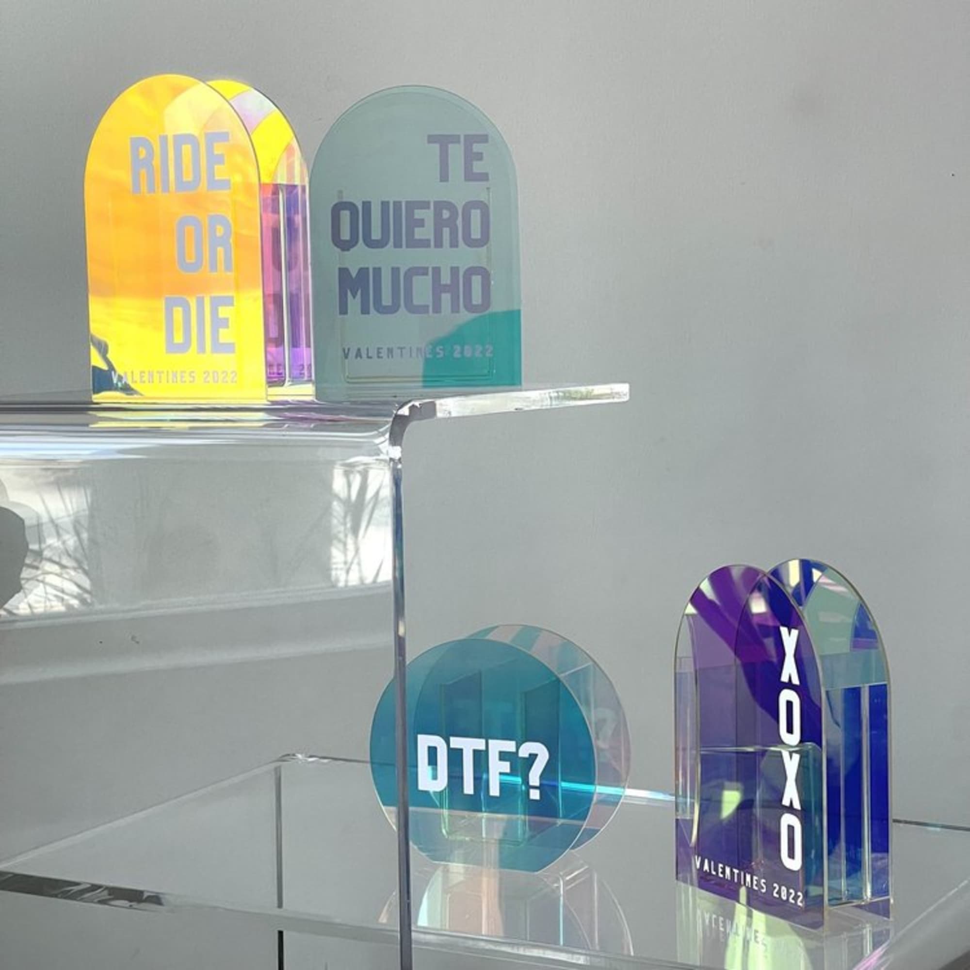 Colorful acrylic signs with bold text on clear stands
