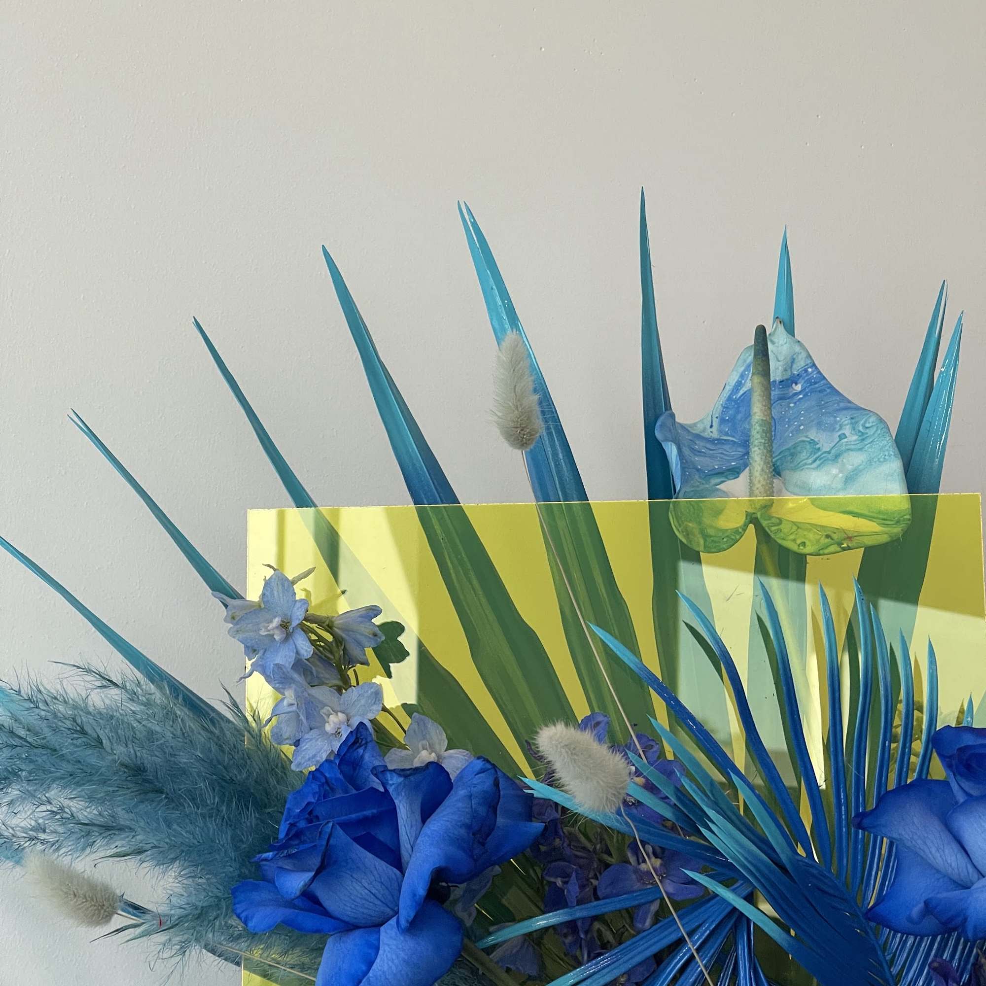 Blue floral arrangement with tropical leaves and anthuriums, photo 2 of 4