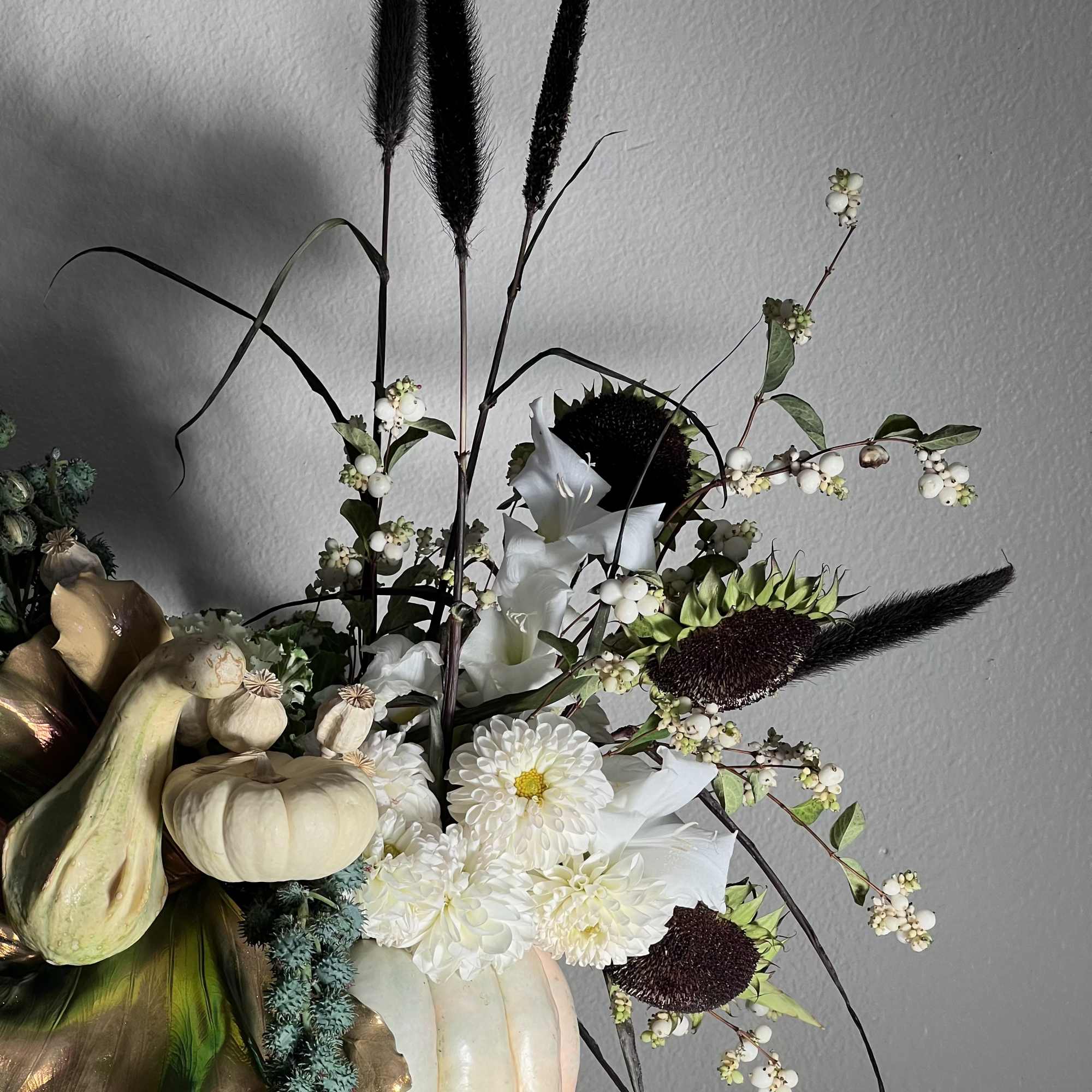 Pumpkin arrangement with white flowers and dark seed heads