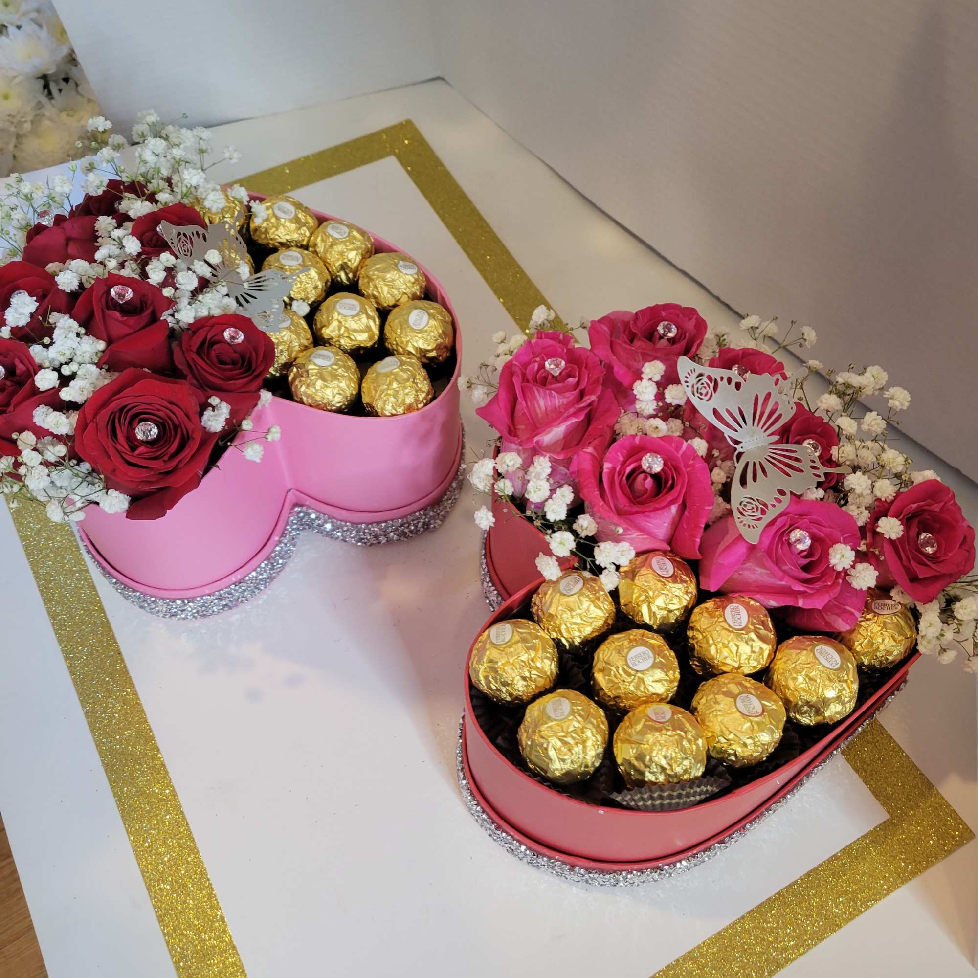 Heart-shaped boxes with roses and gold-wrapped chocolates