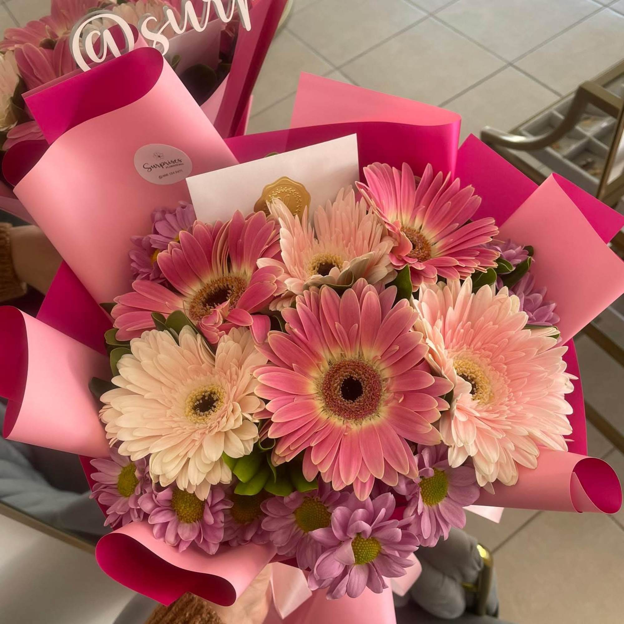 Pink and cream gerbera daisy bouquet wrapped in pink paper