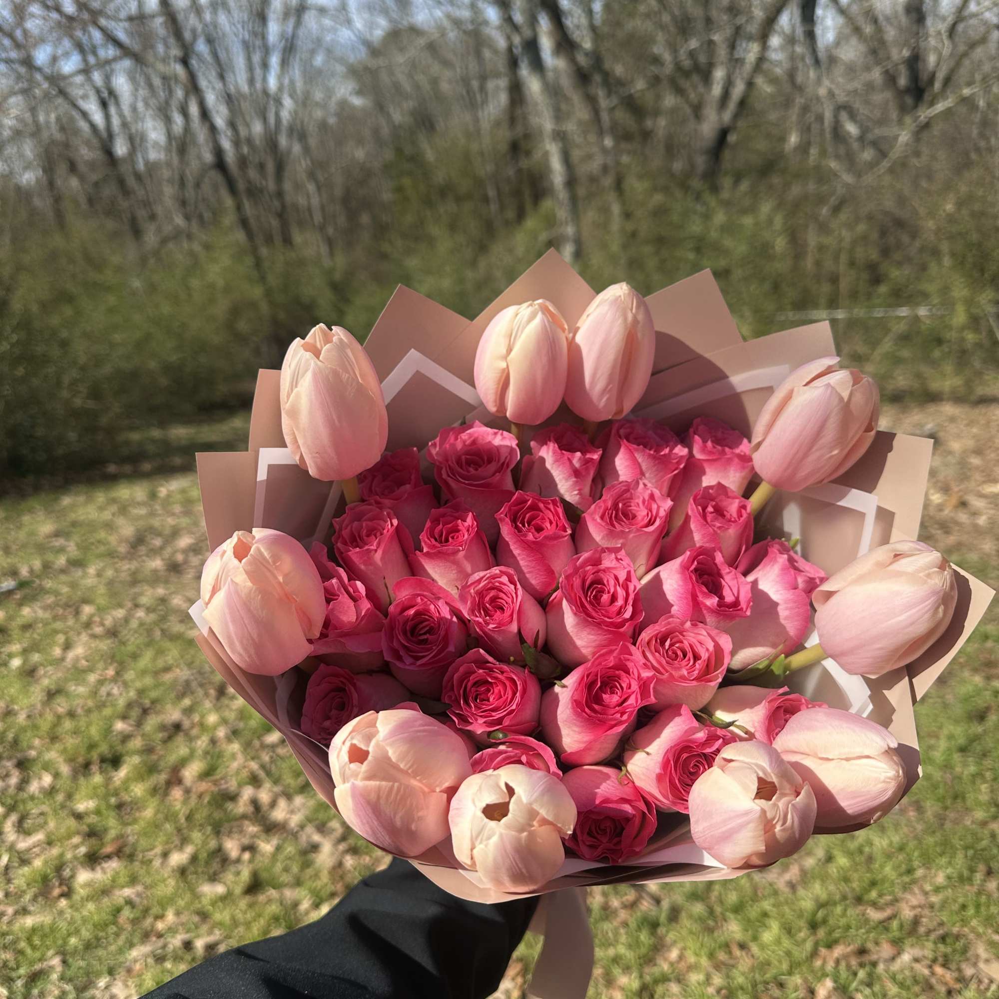 Pink rose and tulip bouquet wrapped in blush paper