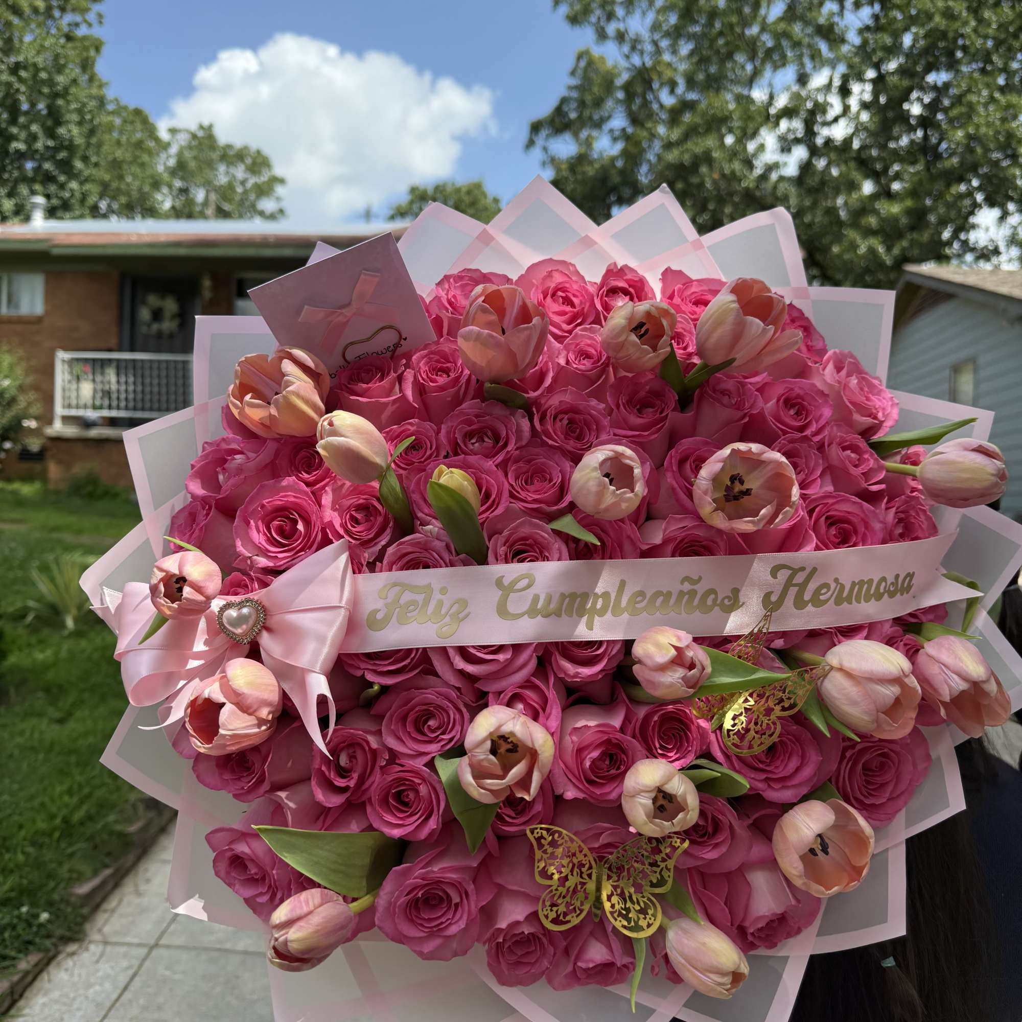 Large pink rose bouquet with pale tulips and a birthday ribbon