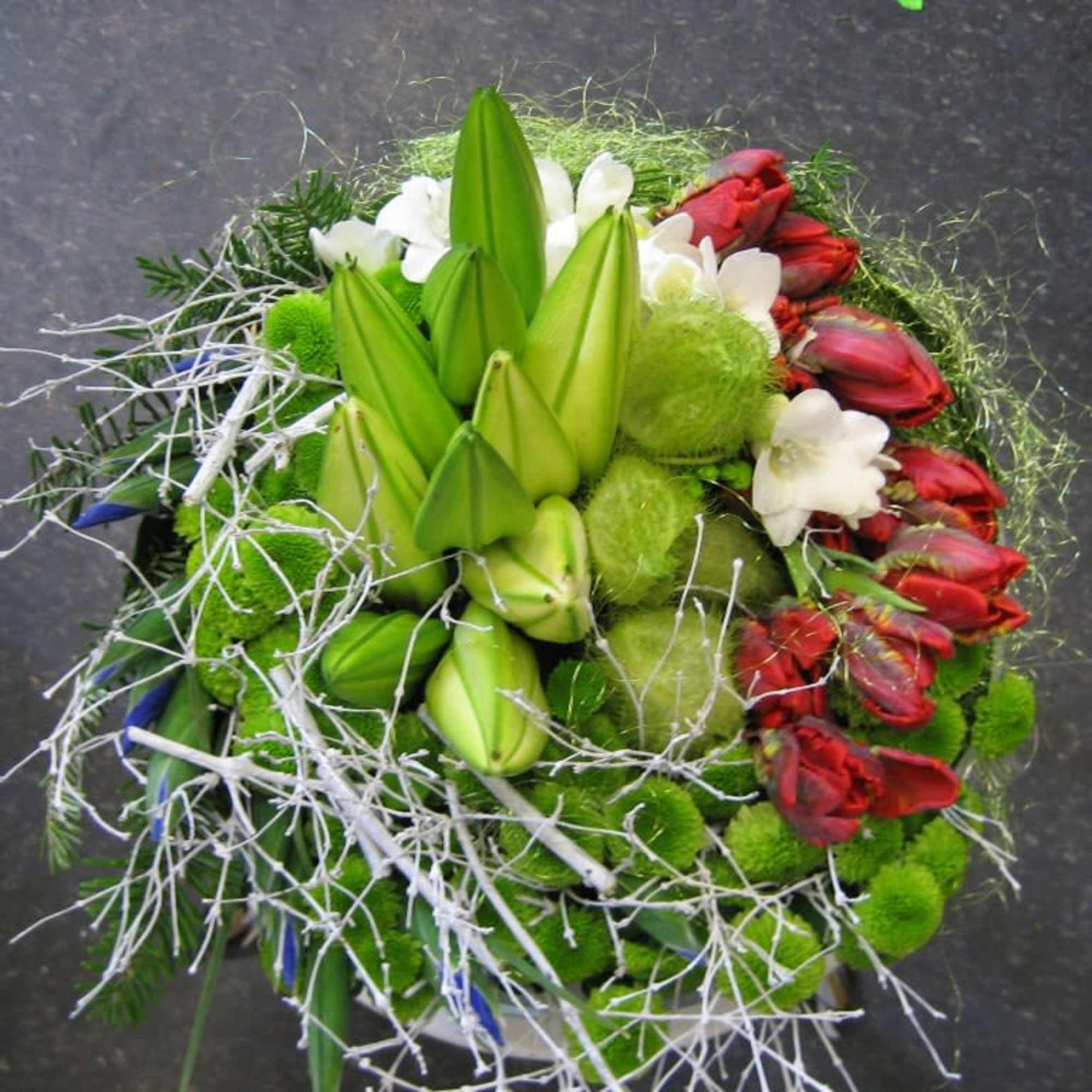 Bouquet with green lilies, red tulips, and white flowers