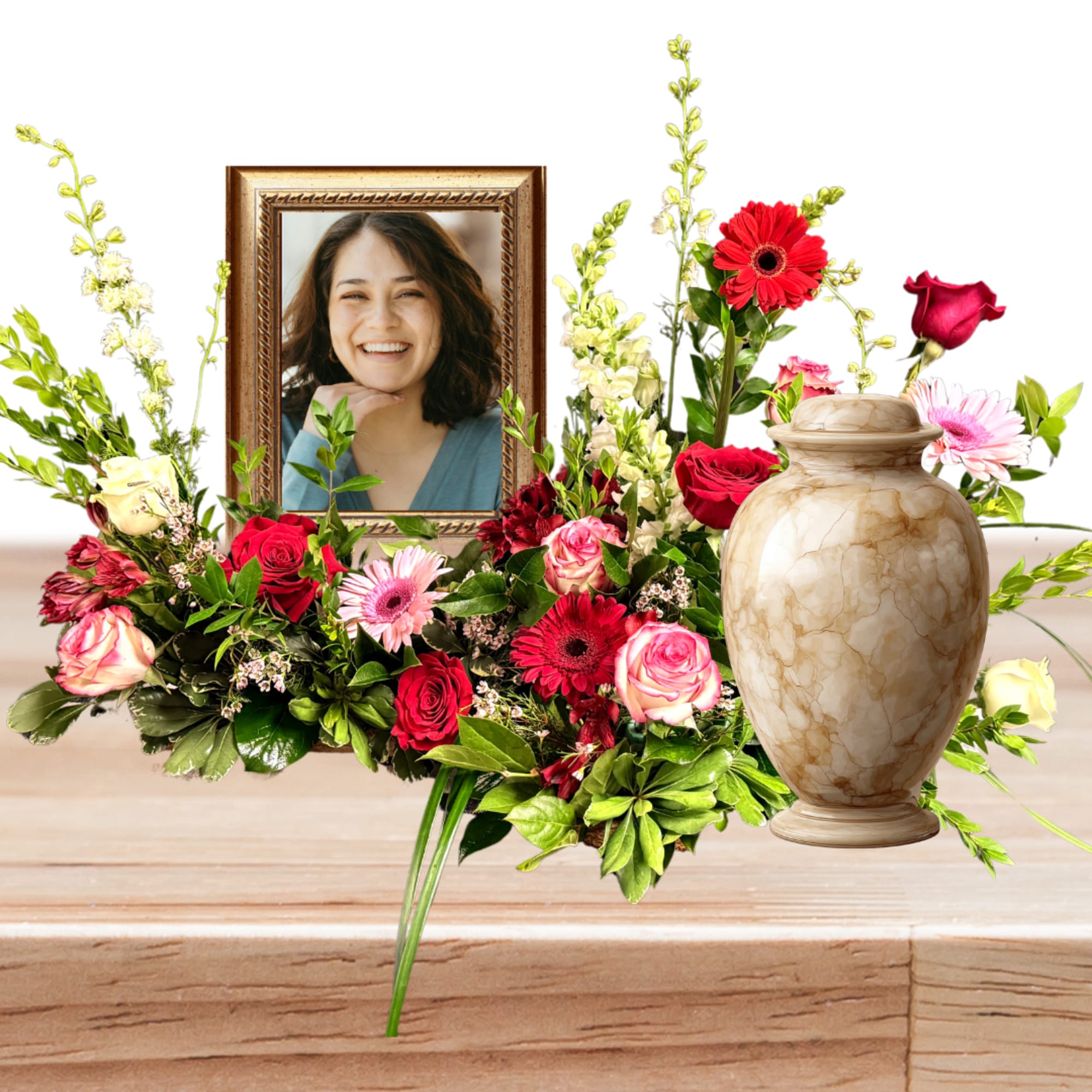 Floral tribute with a framed portrait and urn surrounded by red and pink roses
