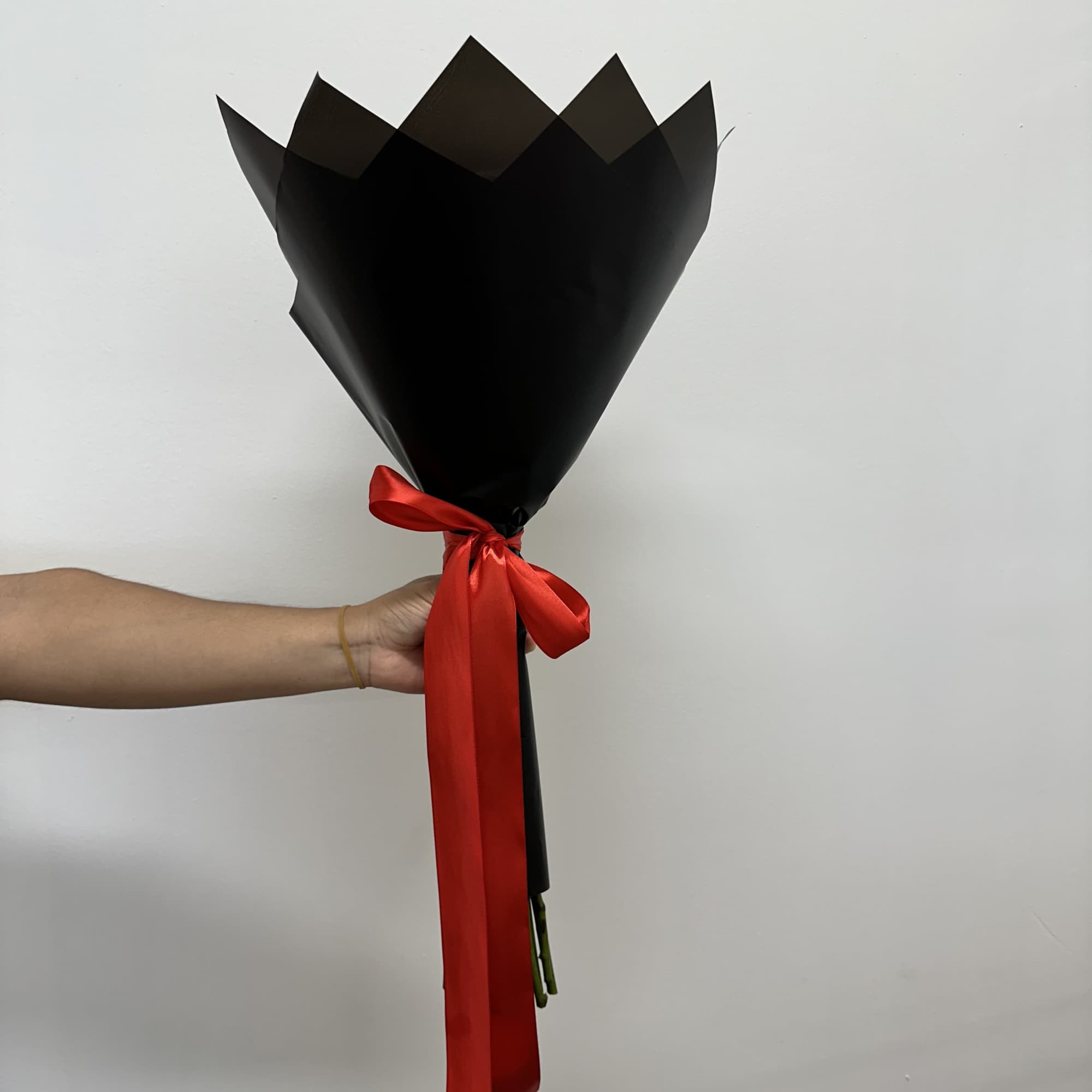 This striking arrangement features vibrant red roses, beautifully wrapped in sophisticated black, photo 2 of 2