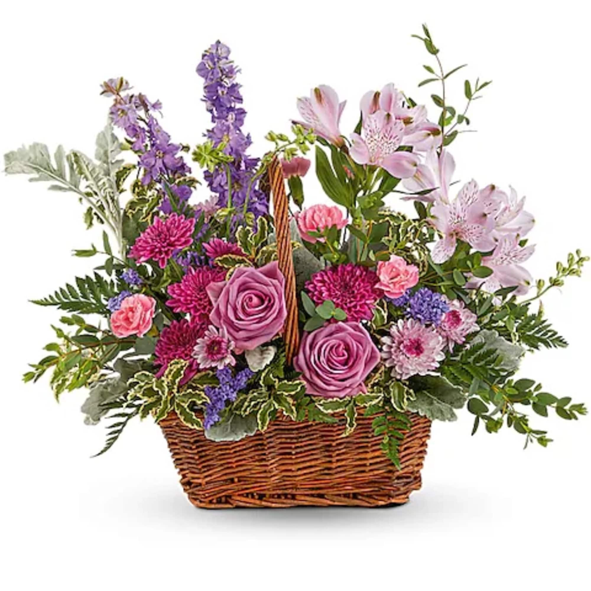 Mixed flower basket with pink and purple blooms in a wicker basket