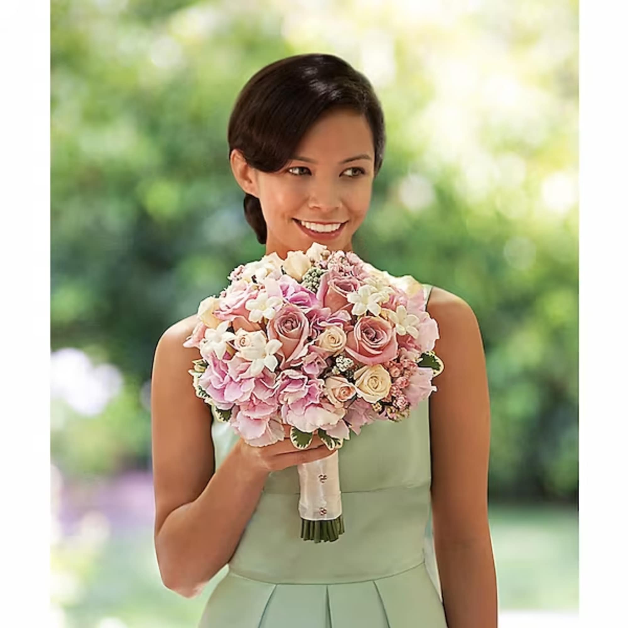 Woman holding a pink and white bridal bouquet
