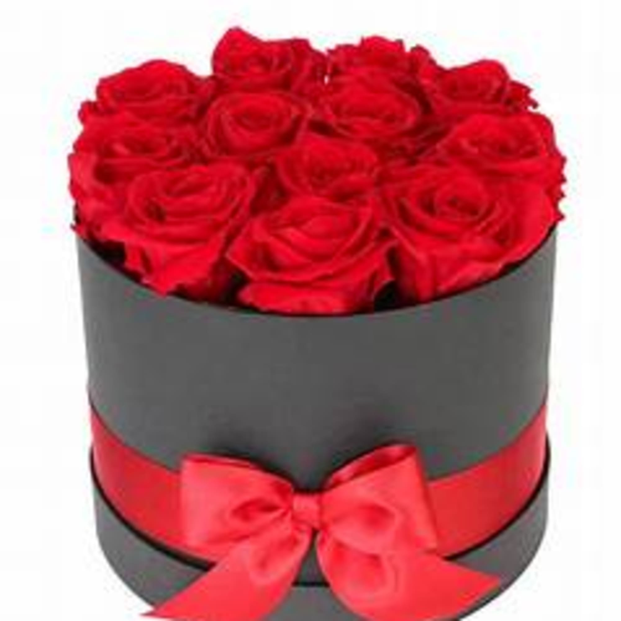 Red roses arranged in a round black box with a red ribbon bow