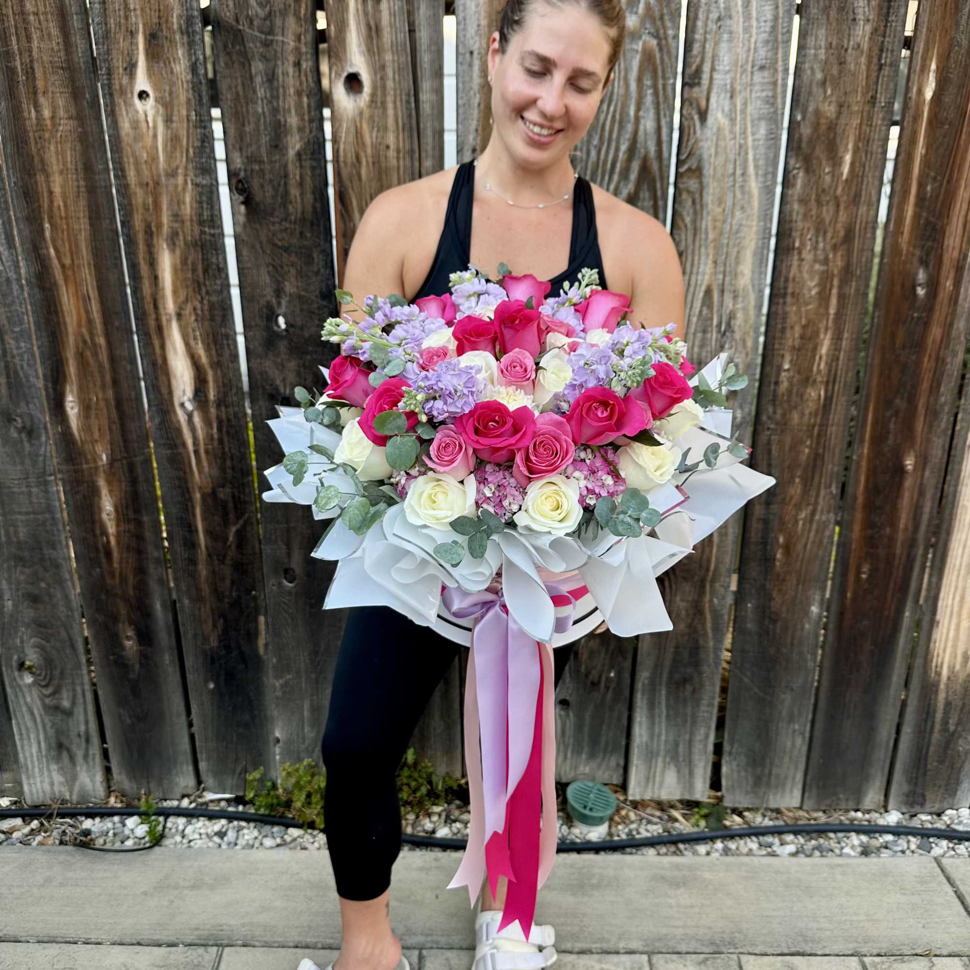 Large bouquet of pink and white roses with lavender flowers
