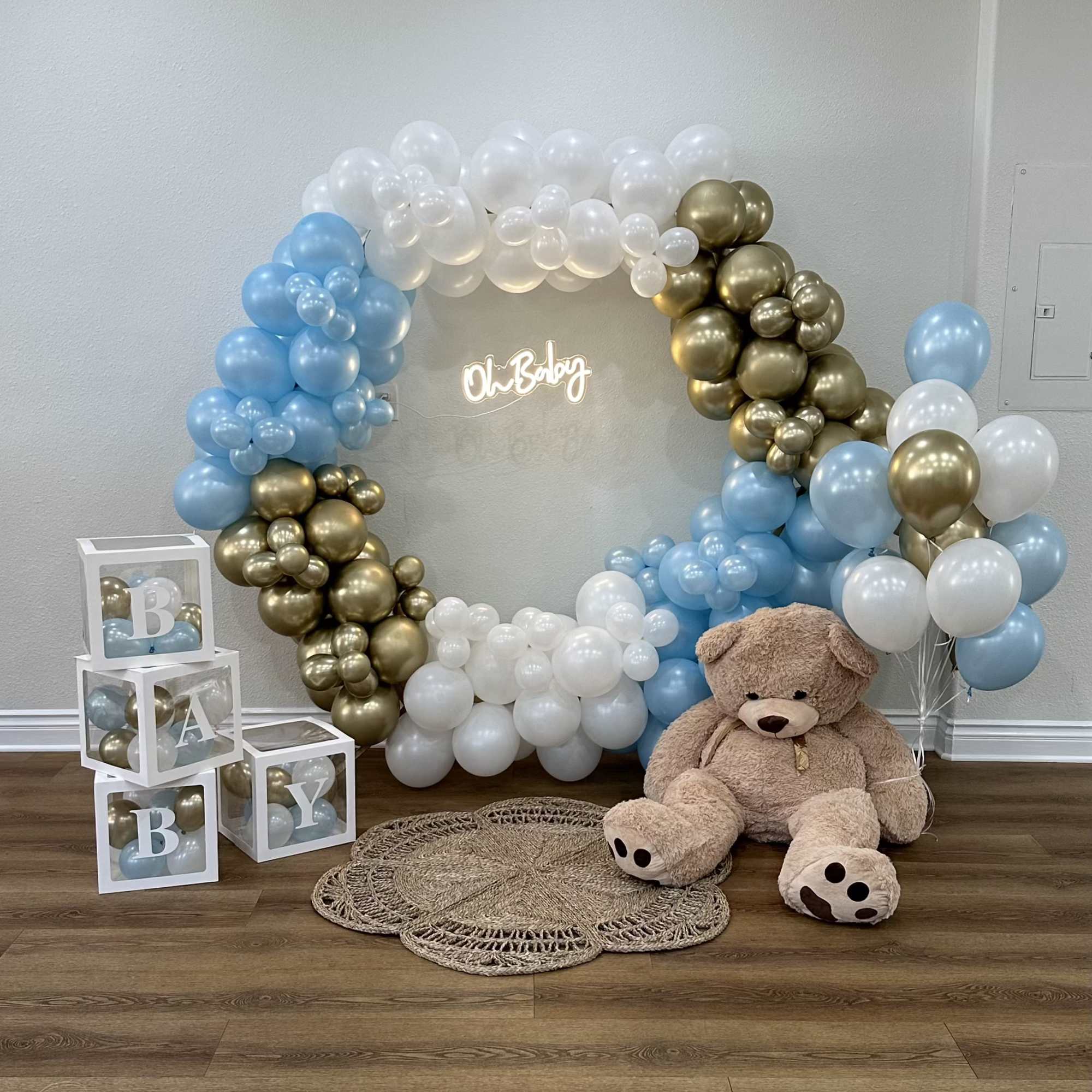 Baby shower balloon arch with teddy bear and letter blocks