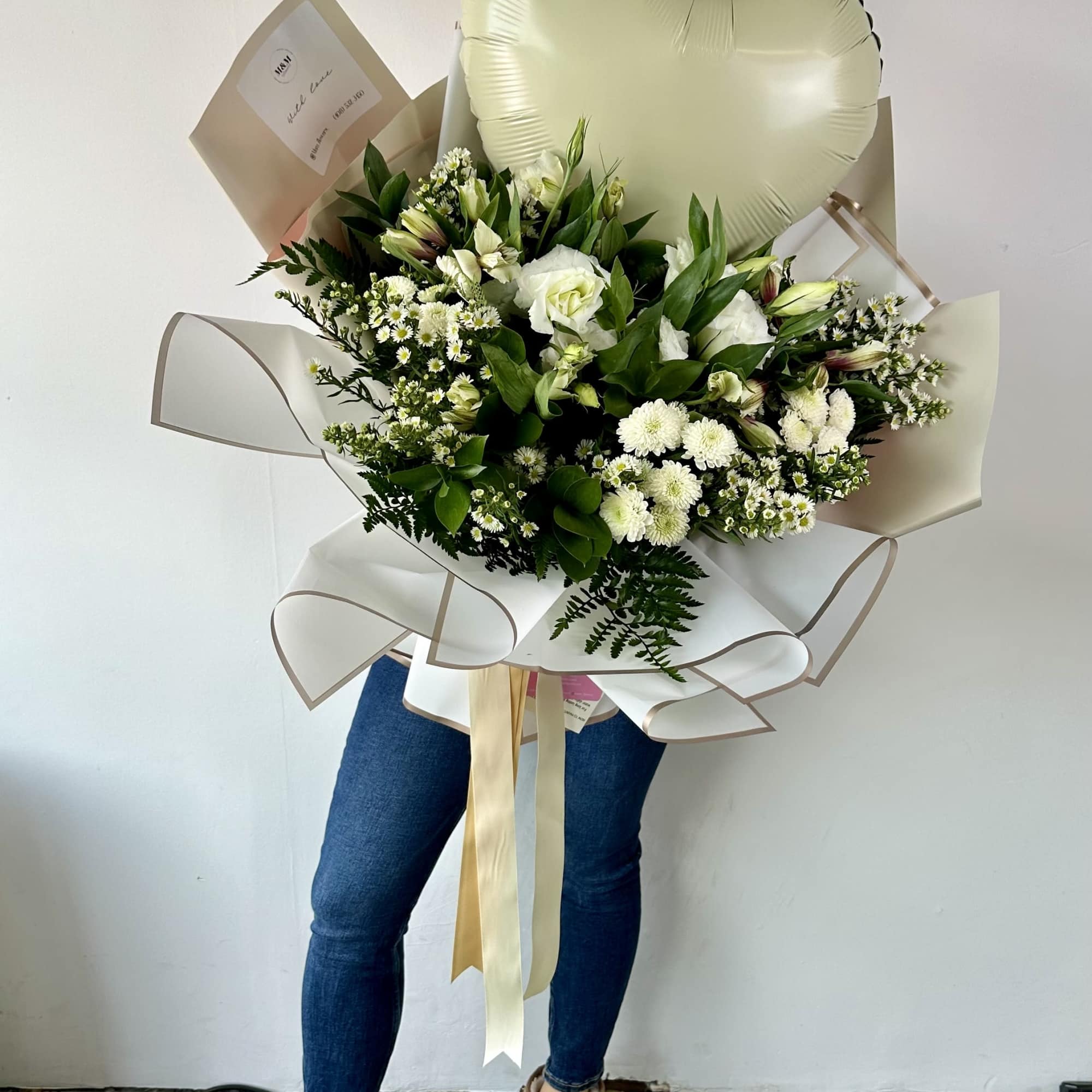 Large white bouquet with a heart-shaped balloon