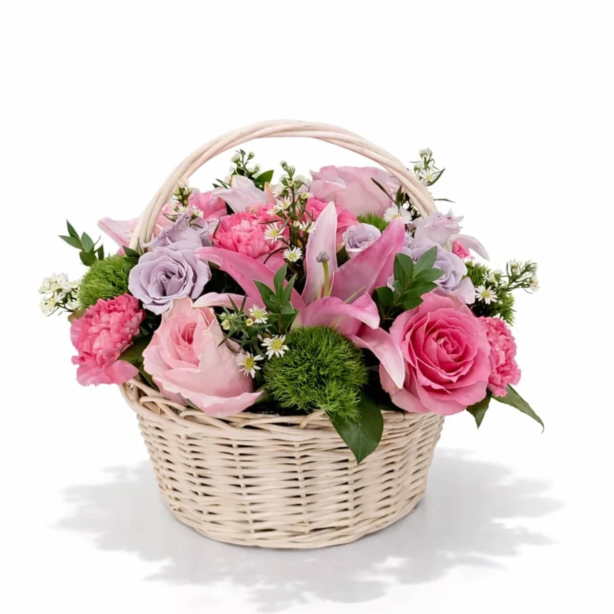 Pink and lavender flowers arranged in a wicker basket