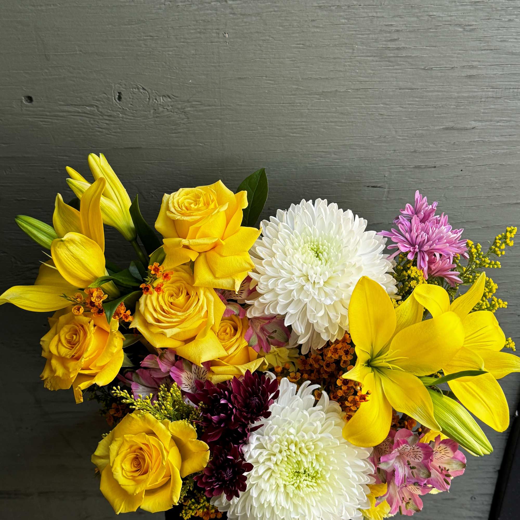 Bouquet of yellow roses, white chrysanthemums, and lilies