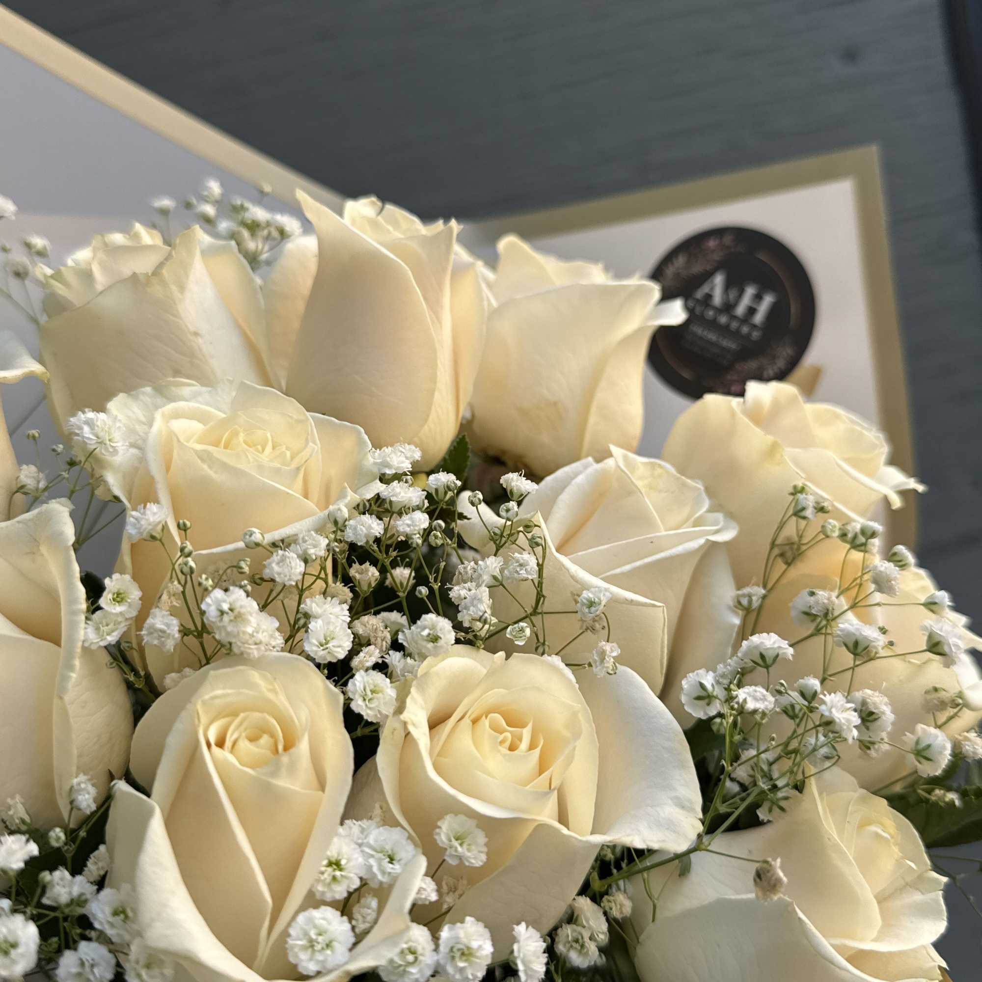 Bouquet of cream roses with small white filler flowers
