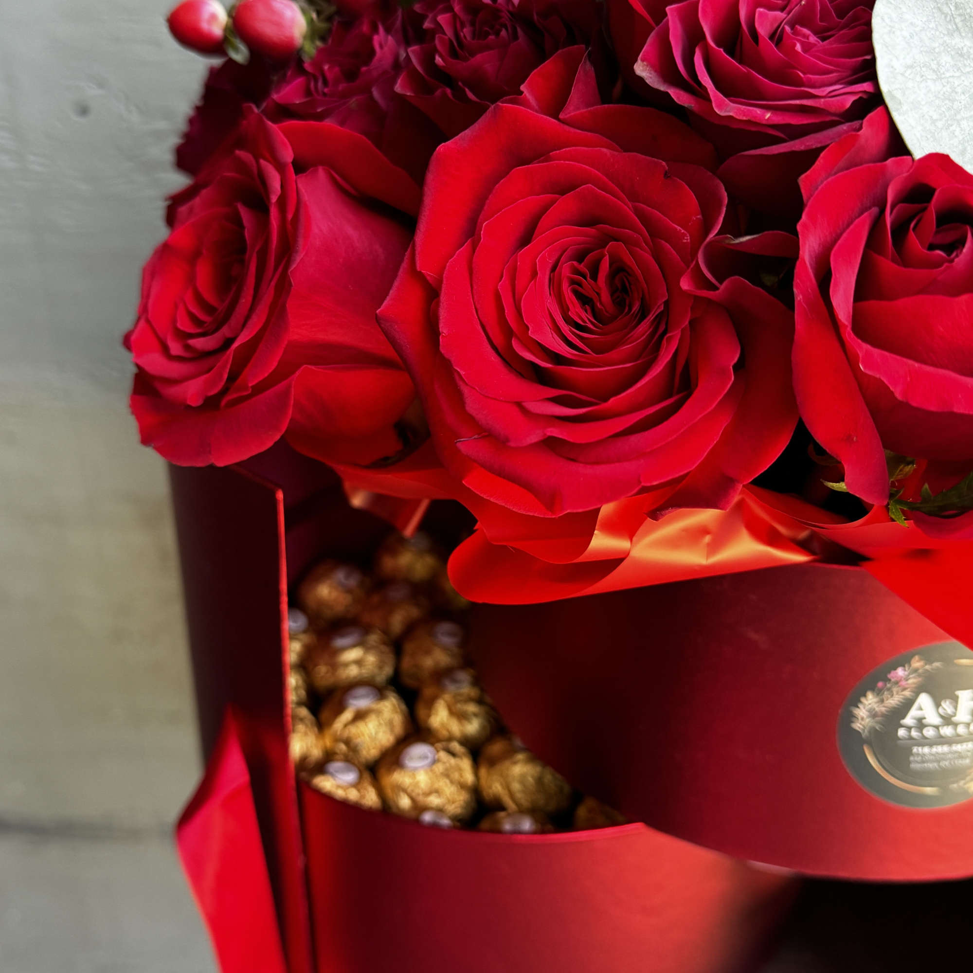 Red rose bouquet with Ferrero Rocher chocolates in a red box