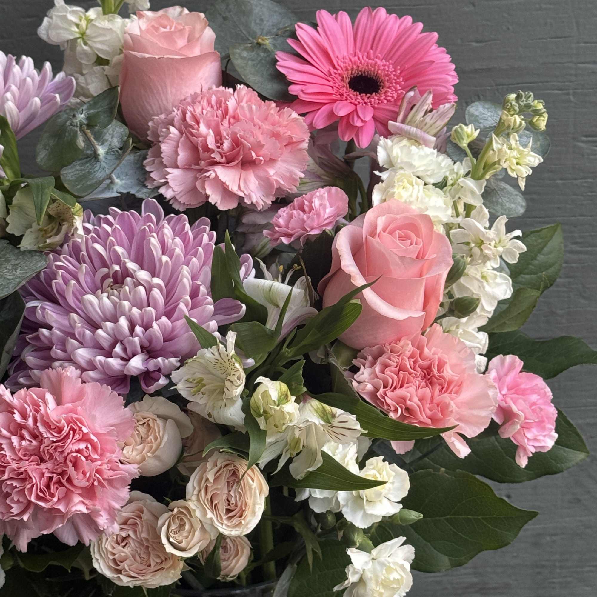 Pink and white mixed bouquet with roses, carnations, and daisies