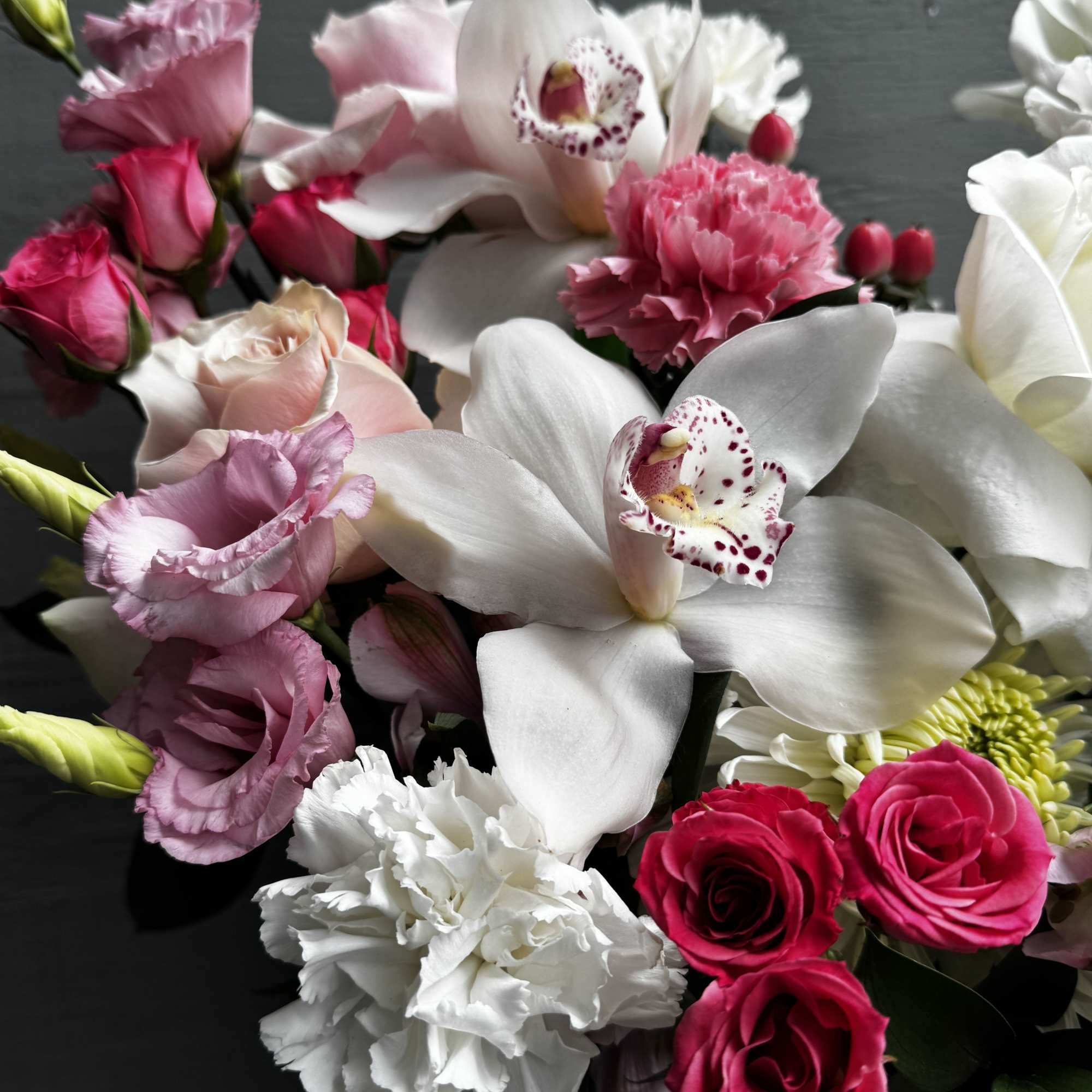 Bouquet of pink and white flowers with orchids and roses