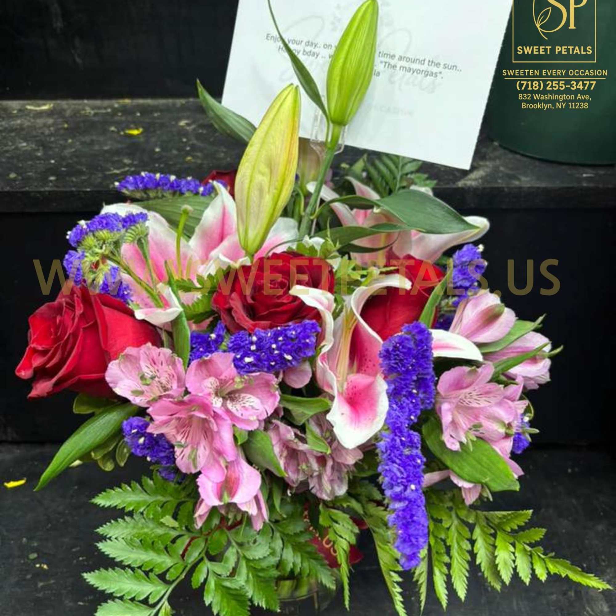 Bouquet of red roses, pink lilies, and purple filler flowers