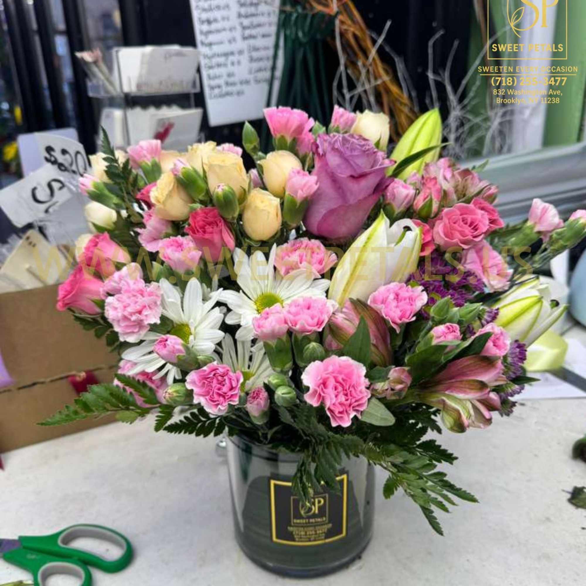 Mixed pink and white bouquet in a black vase