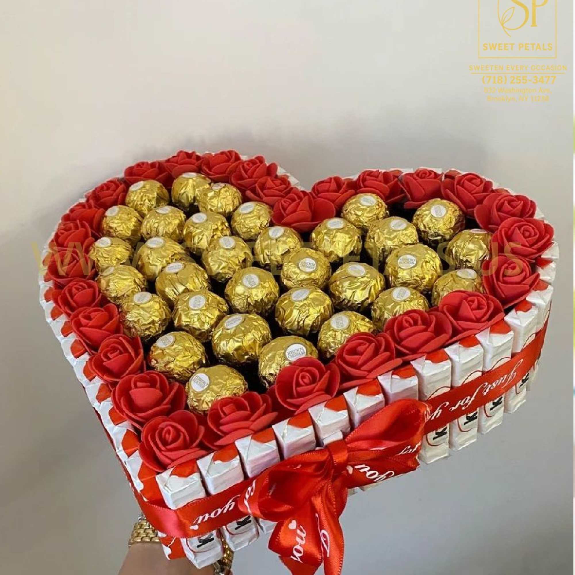 Heart-shaped gift box with red roses and gold-wrapped chocolates