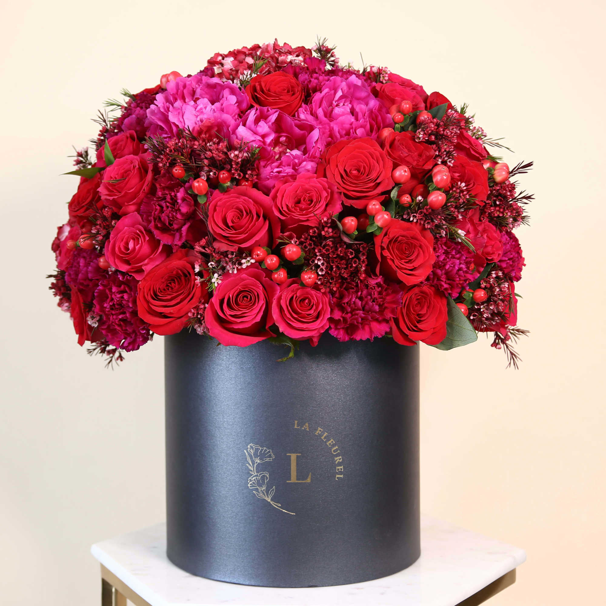 This amazing arrangement filled with the red roses,hydrangeas, greens and peonies to, photo 2 of 2