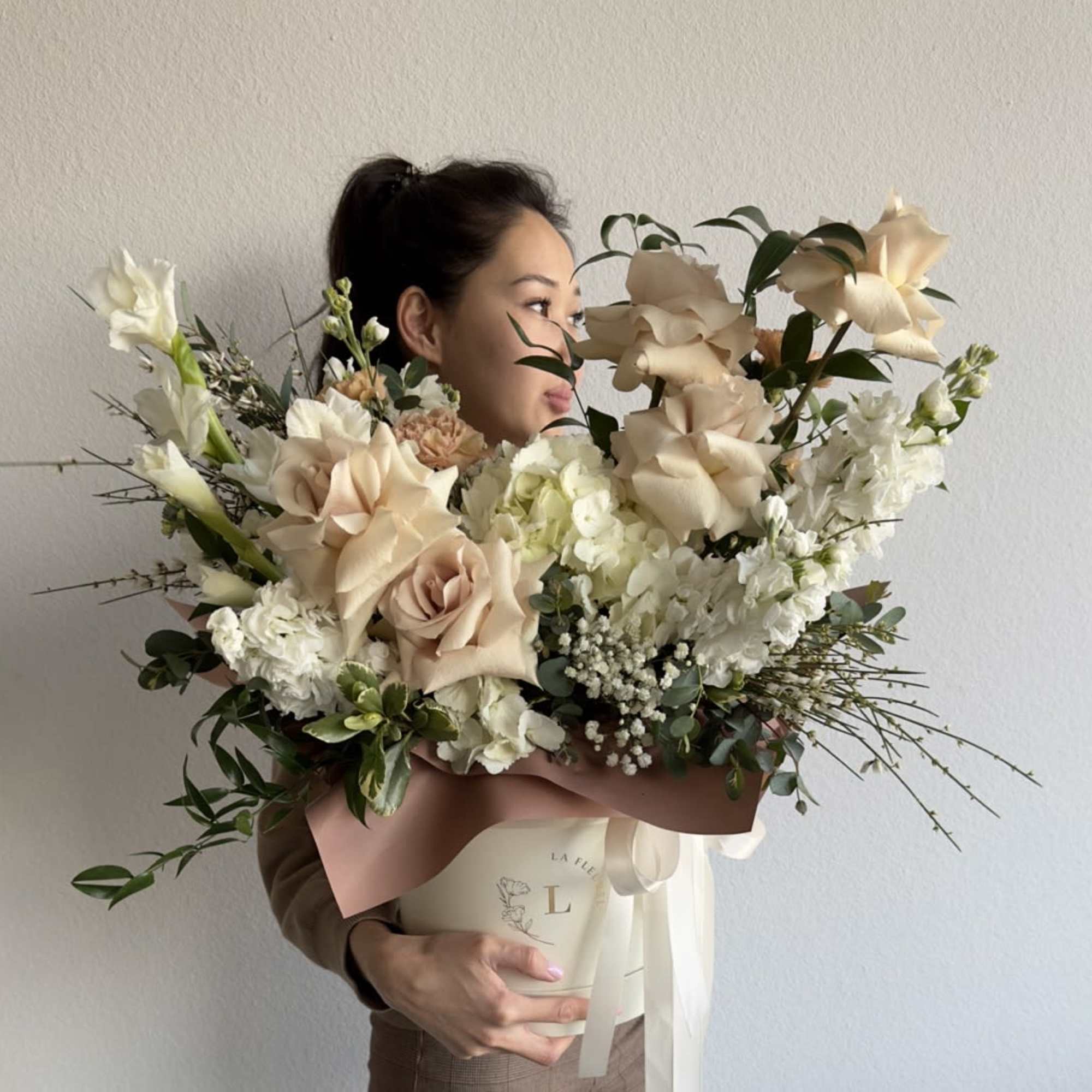 This beautiful arrangement is filled with beige roses, hydrangeas, carnations and greens, photo 2 of 2