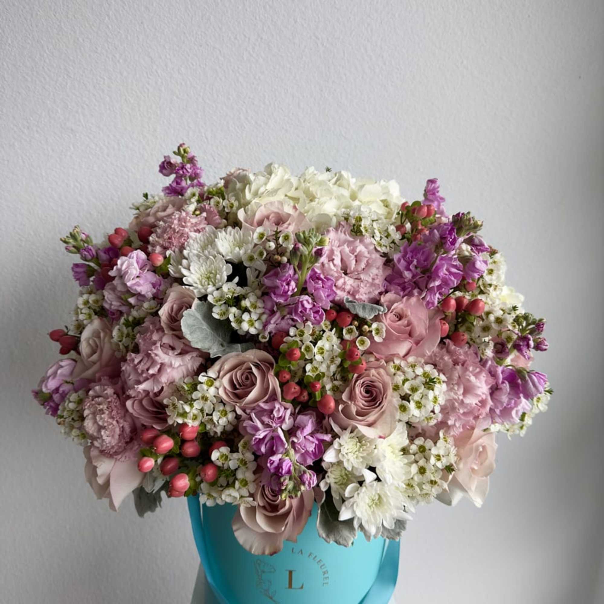 This beautiful arrangement is filled with pink roses, hydrangeas, stock, coffee beans