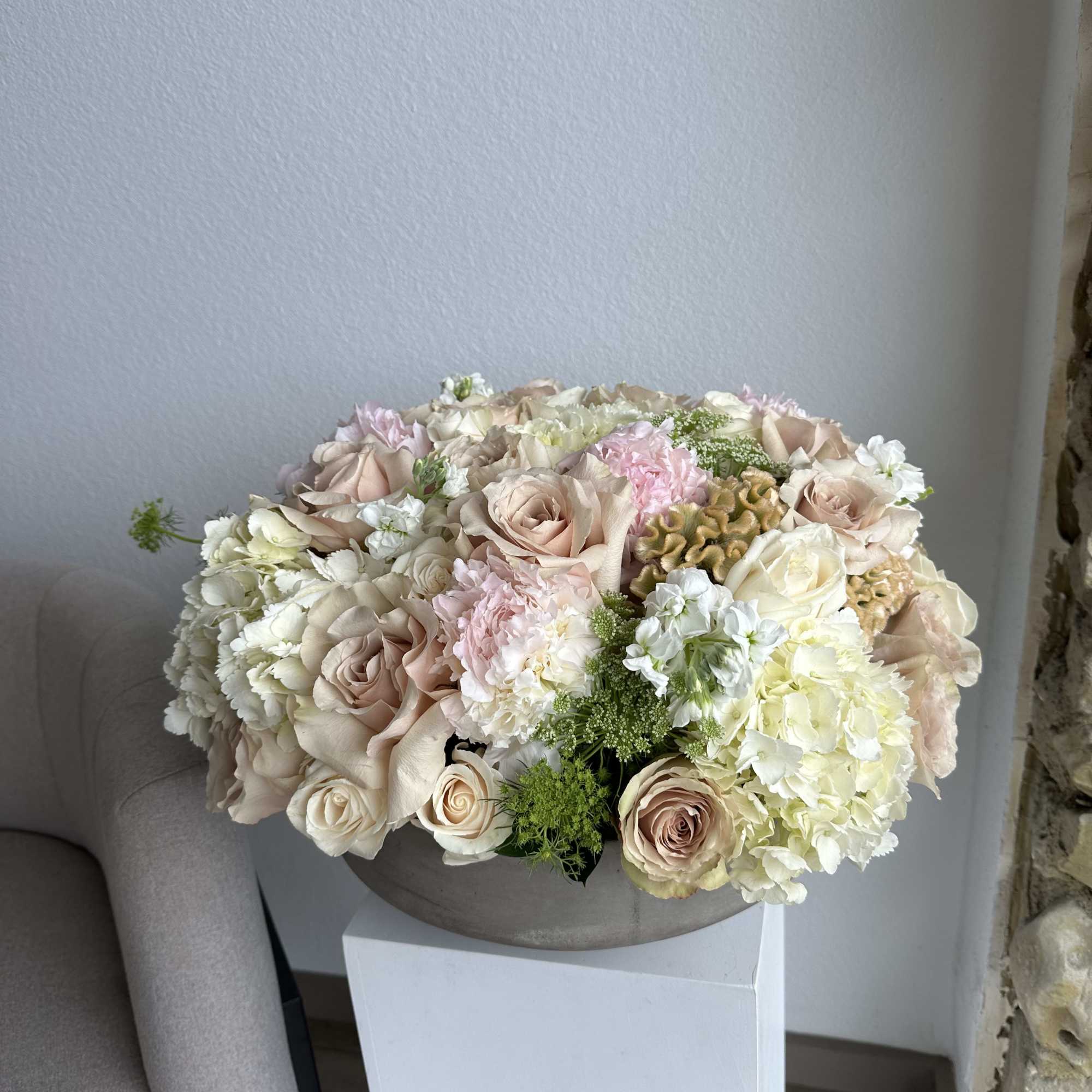 This beautiful arrangement filled with the roses, hydrangeas, peonies and greens to