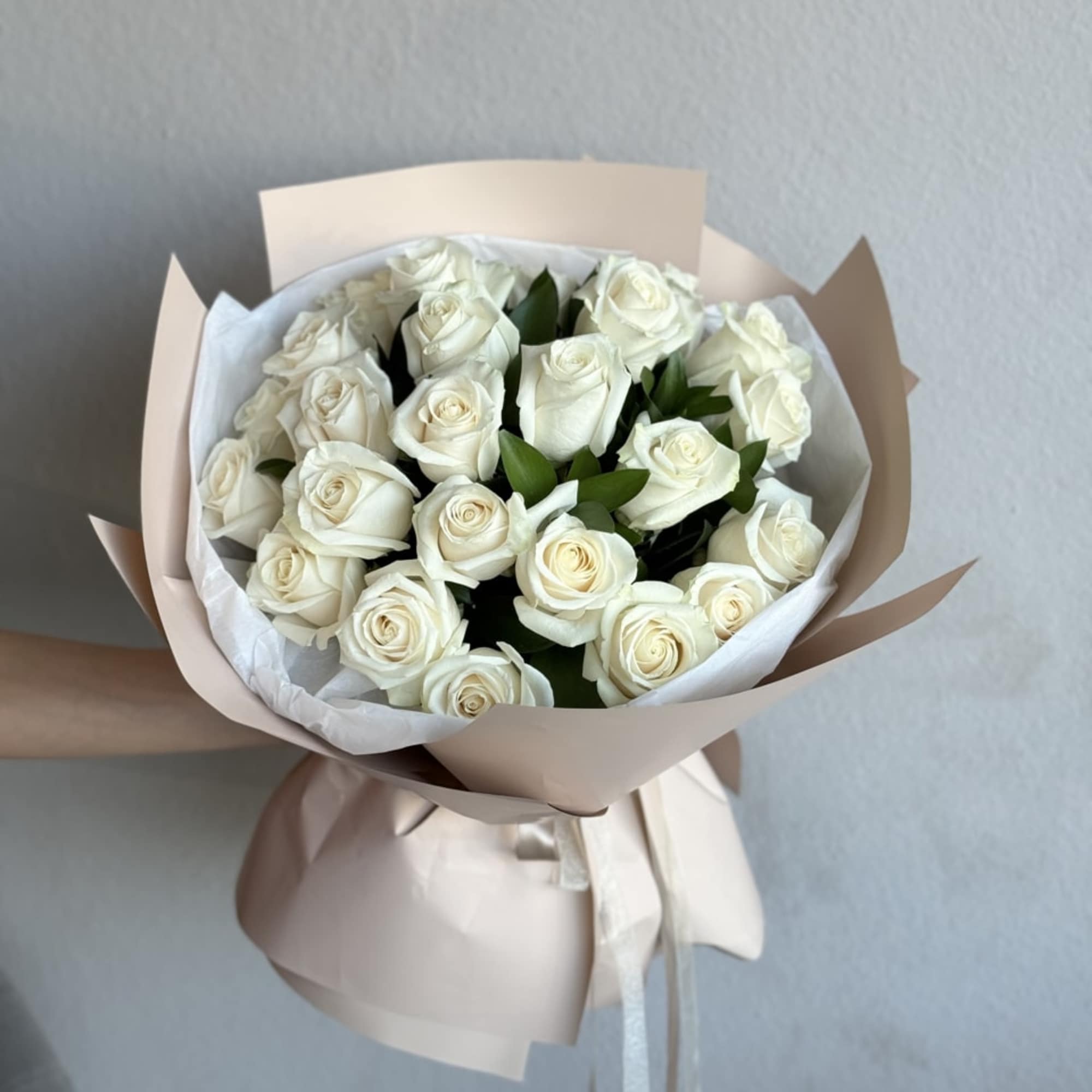 An exquisite hand-held bouquet, including 25 White Vendetta Roses, symbolizing purity and