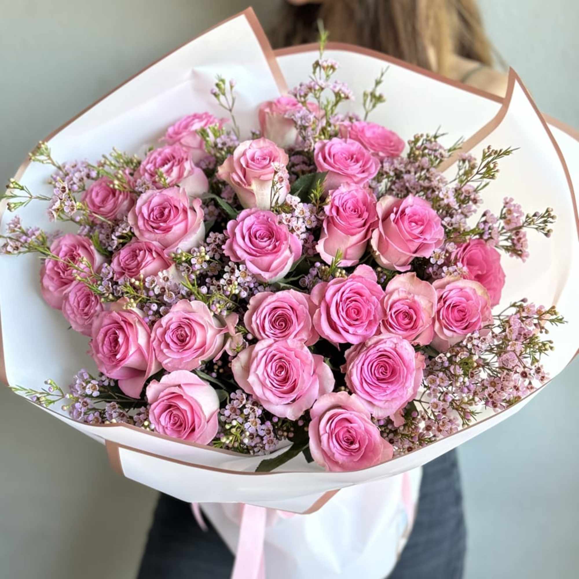 An enchanting hand-held bouquet, featuring 25 Sweet Unique Pink Roses, each petal
