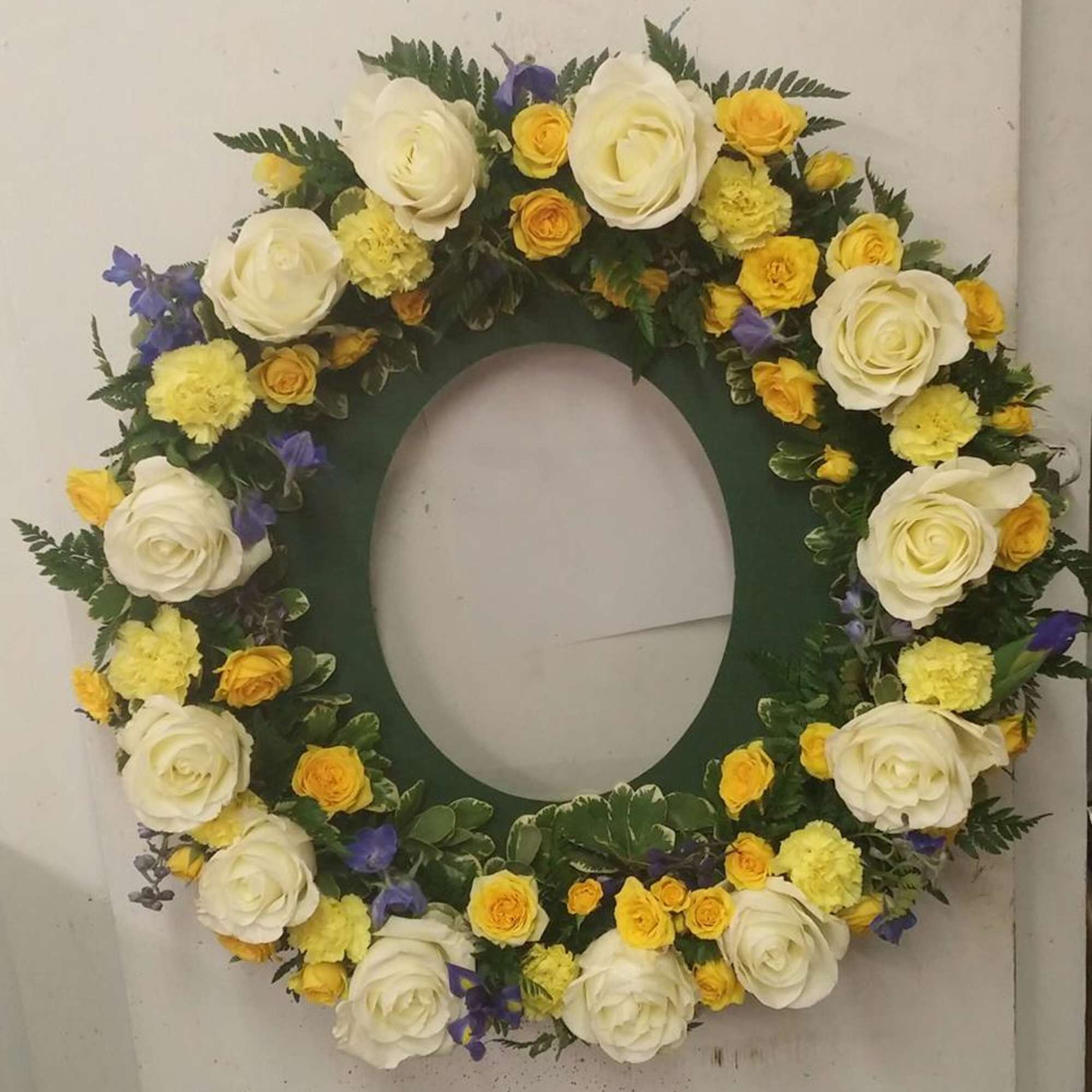 This wreath comes with a plastic insert to hold a photo of