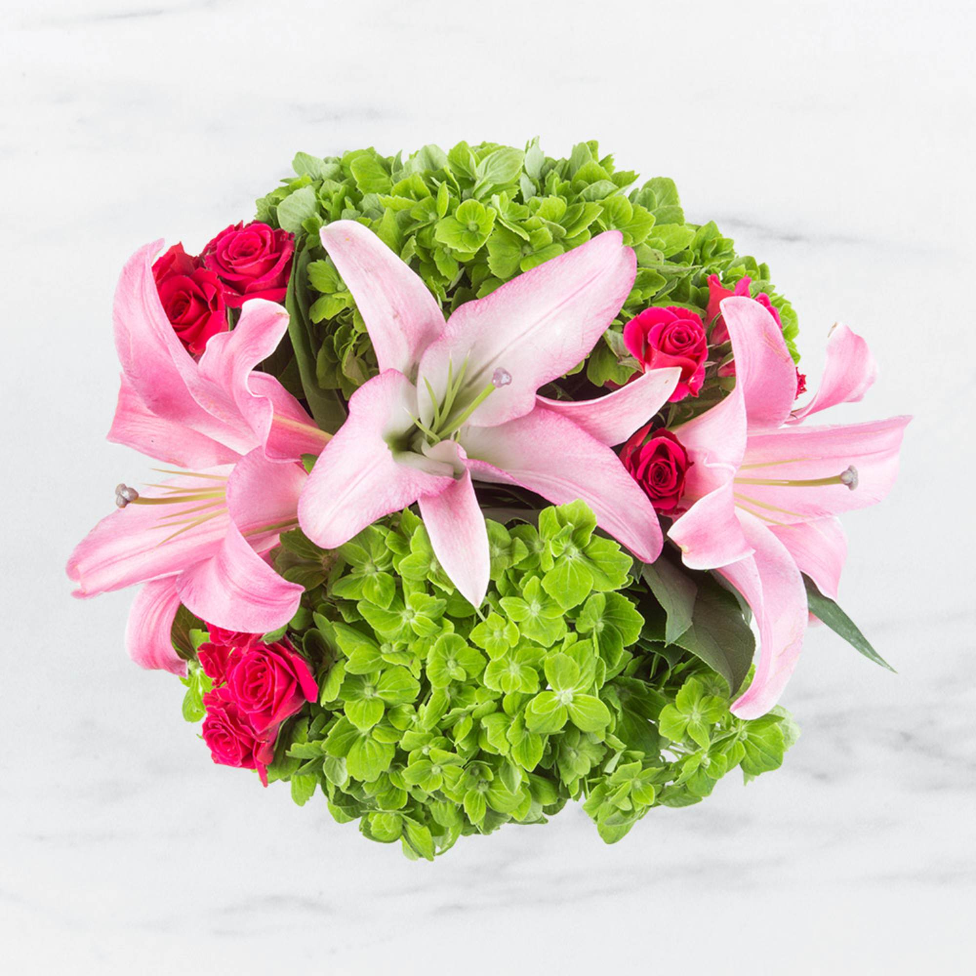 This colorful, spring bouquet contains lilies, spray roses, and hydrangea. It is