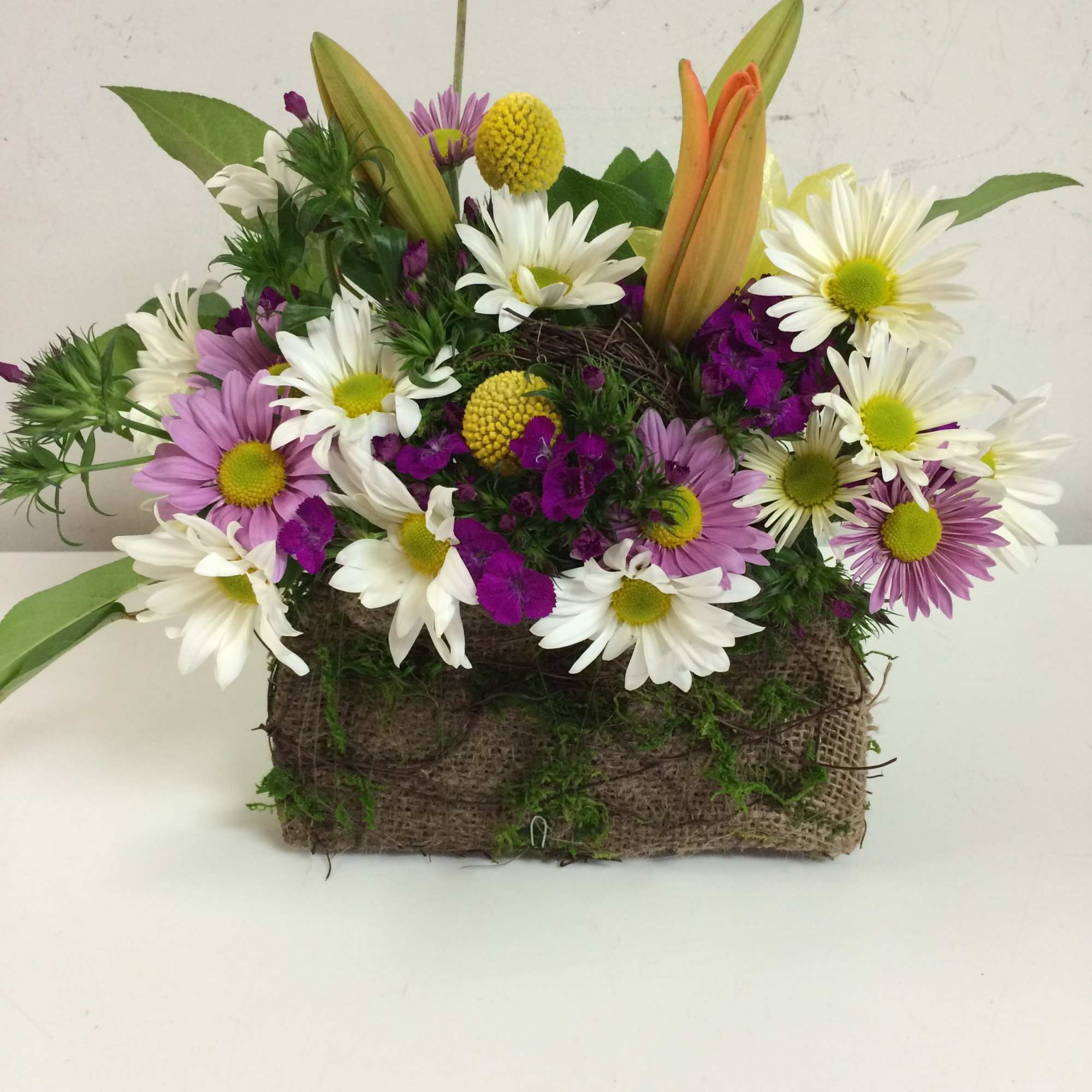 Our designers choice of the freshest flowers in a cute burlap &amp;