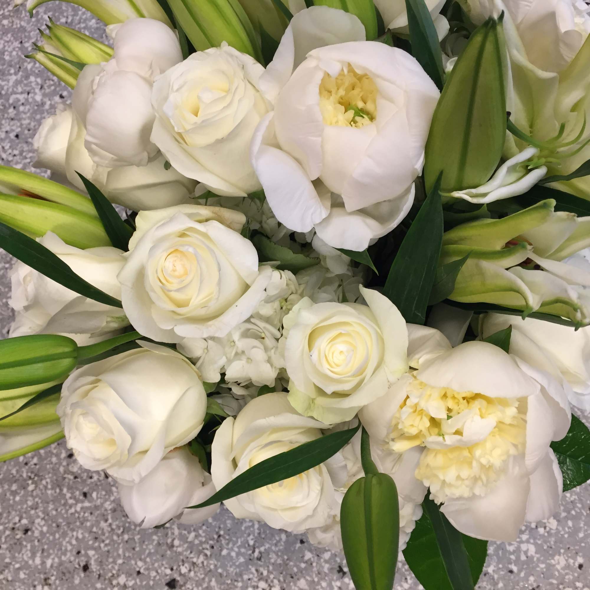 A lushly full arrangement of all winter whites. Pictured here are roses
