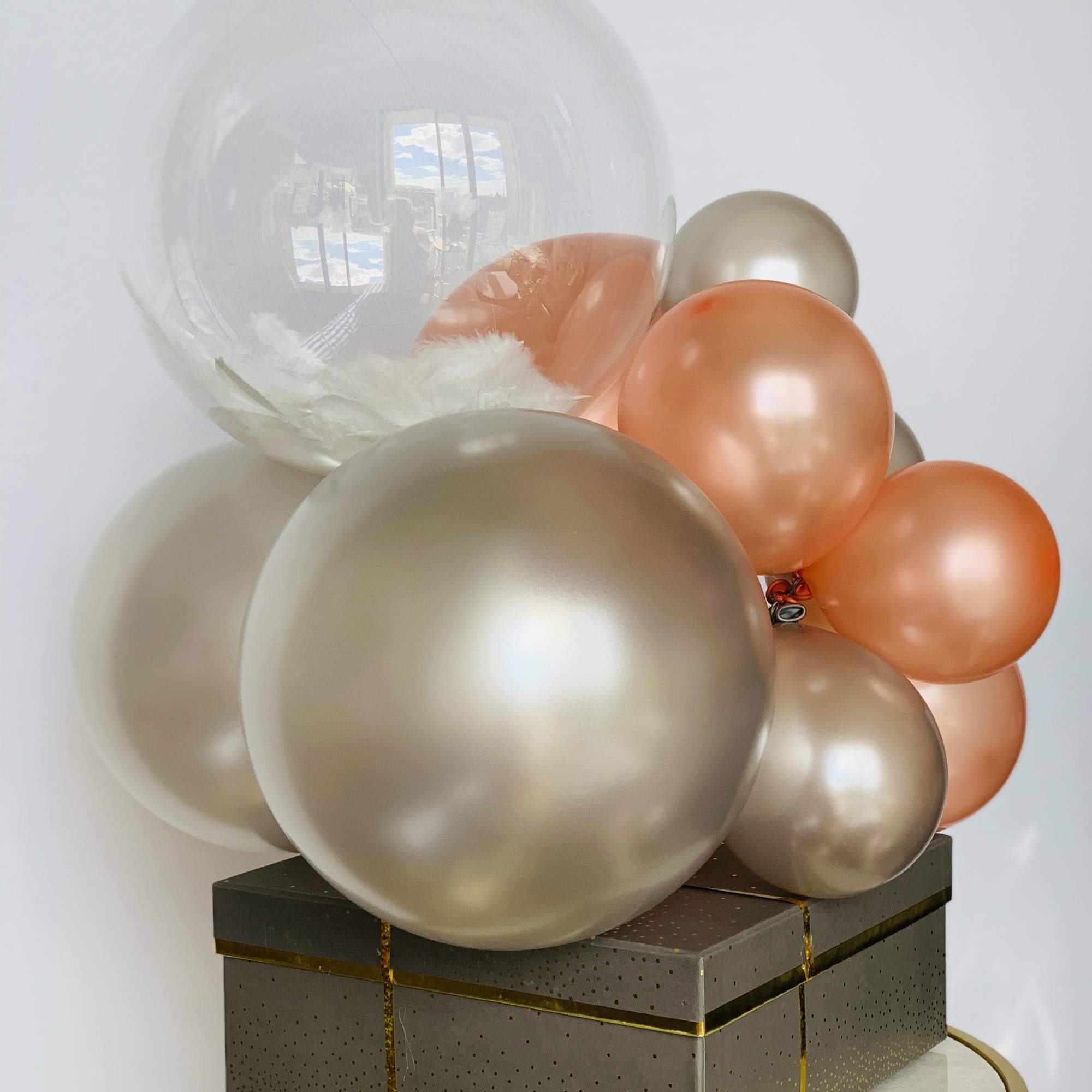 A Godiva chocolate gift box warped with the ribbon and crowned with